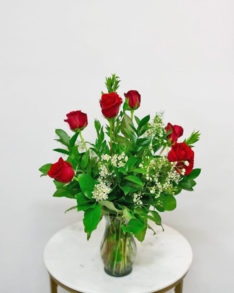 Dozen Red Roses - 12 Red Roses arranged with greenery and filler in a simple vase. Always a classic choice.   **Other colors available upon special request
