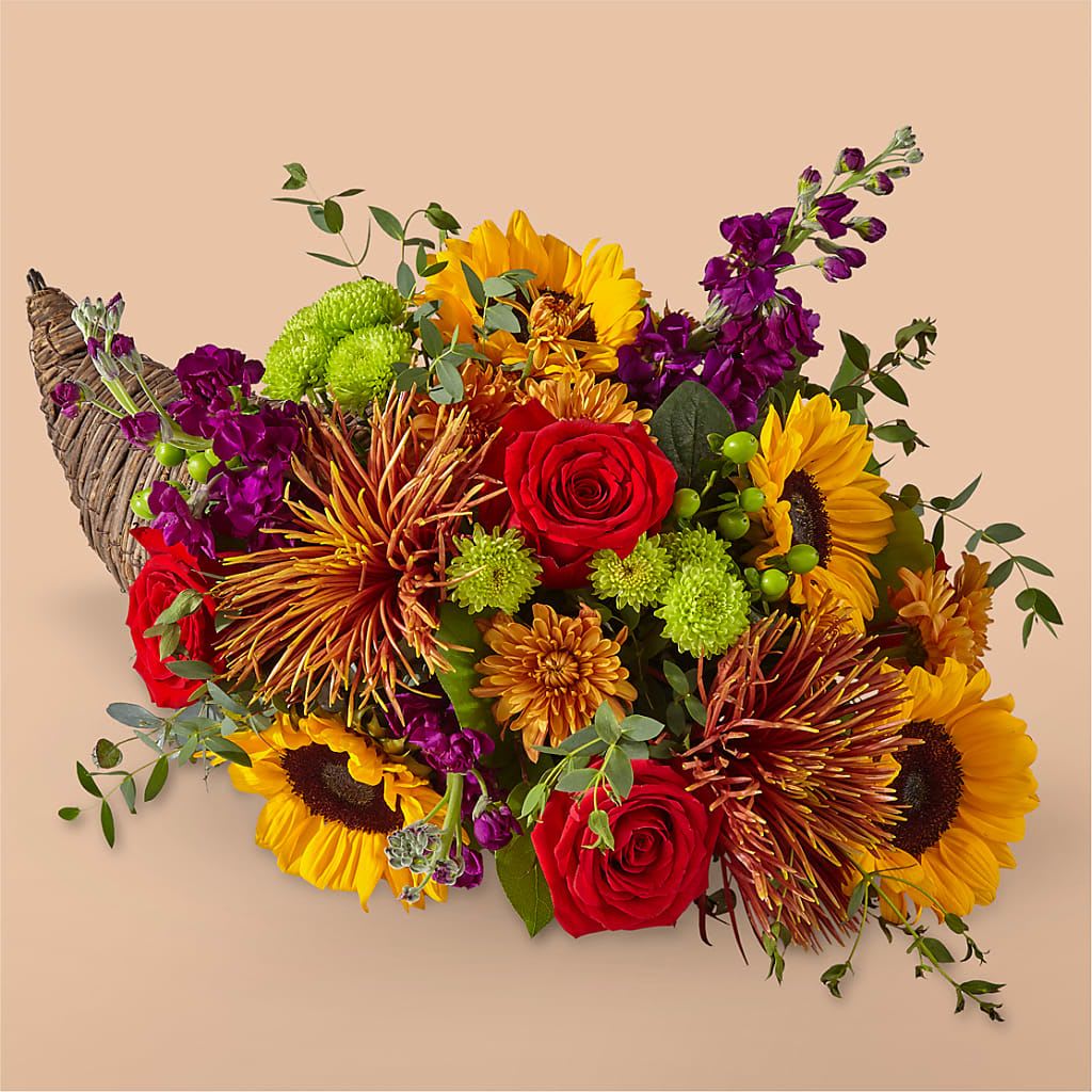 Fall Harvest Cornucopia（Thanksgiving flower basket） - The product includes sunflowers, roses, chrysanthemums, and some green leaves in the same color, wrapped in floral foam, and placed in a flower basket. 