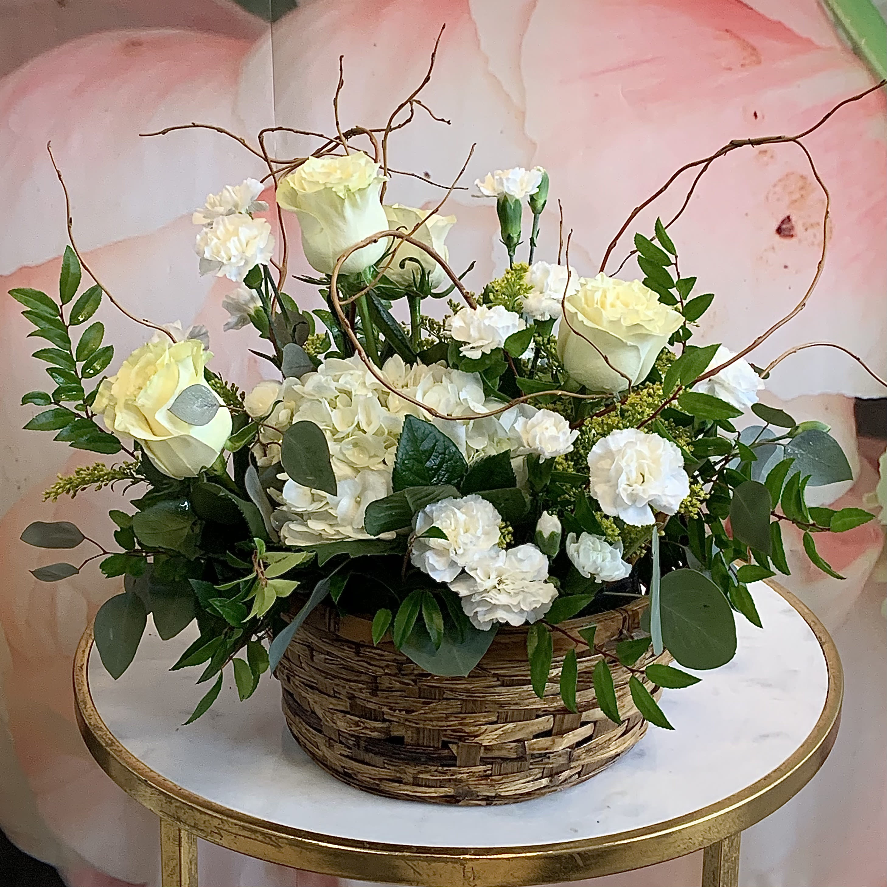 Amazing Grace - A simple arrangement of white lilies and roses, mixed with an assortment of greenery and presented in a wicker basket, can be used to ornament any at-home or business event. An excellent all-purpose selection. Exact container may vary. Please contact us if another container is desired. 