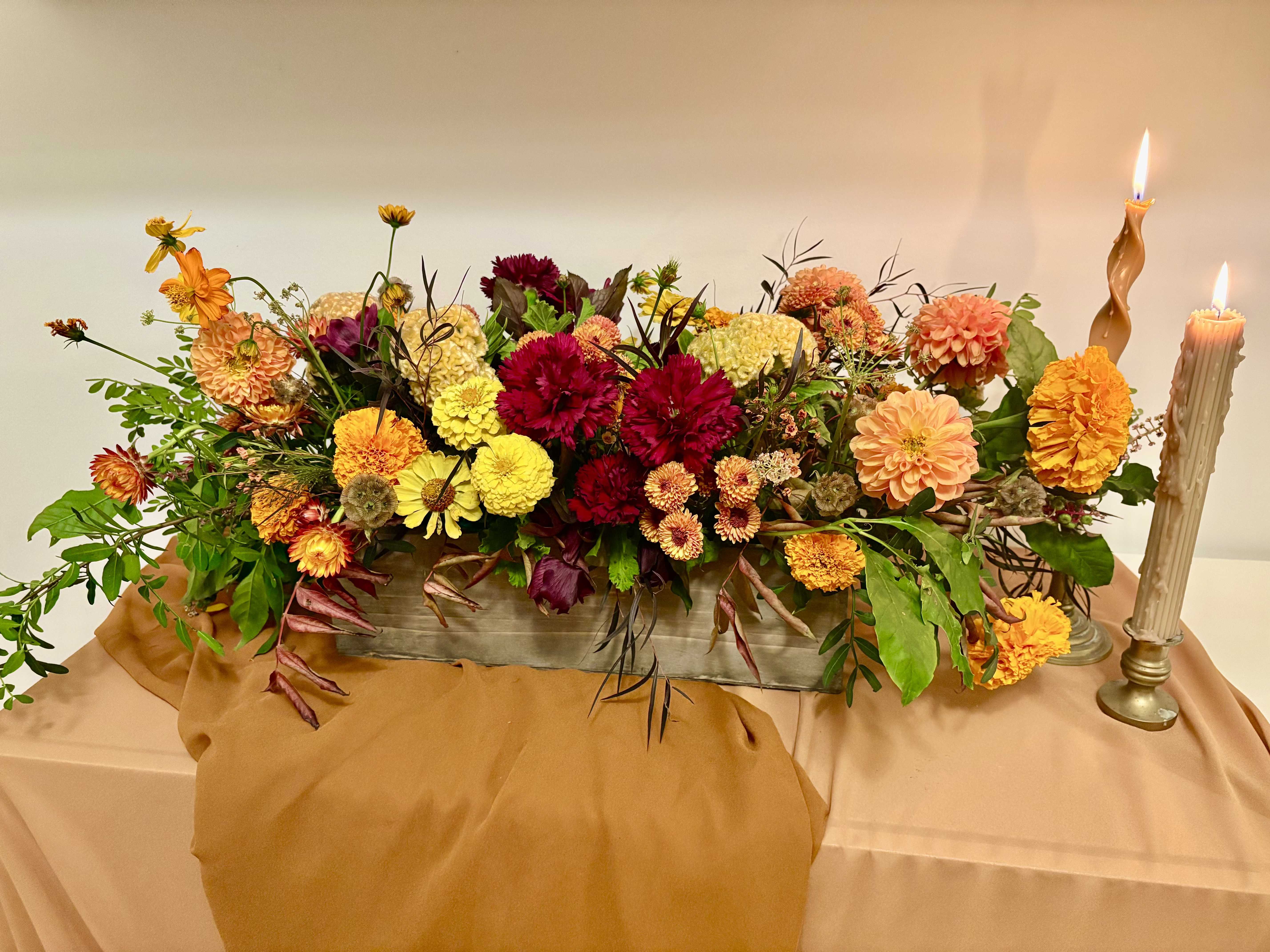 Gather Round Centerpiece - Perfect for the your Thanksgiving tablescape. A rectangular wooden container created at just the right height for your guests to be uninterrupted. Created with the most beautiful Fall blooms in a traditional Thanksgiving color palette.