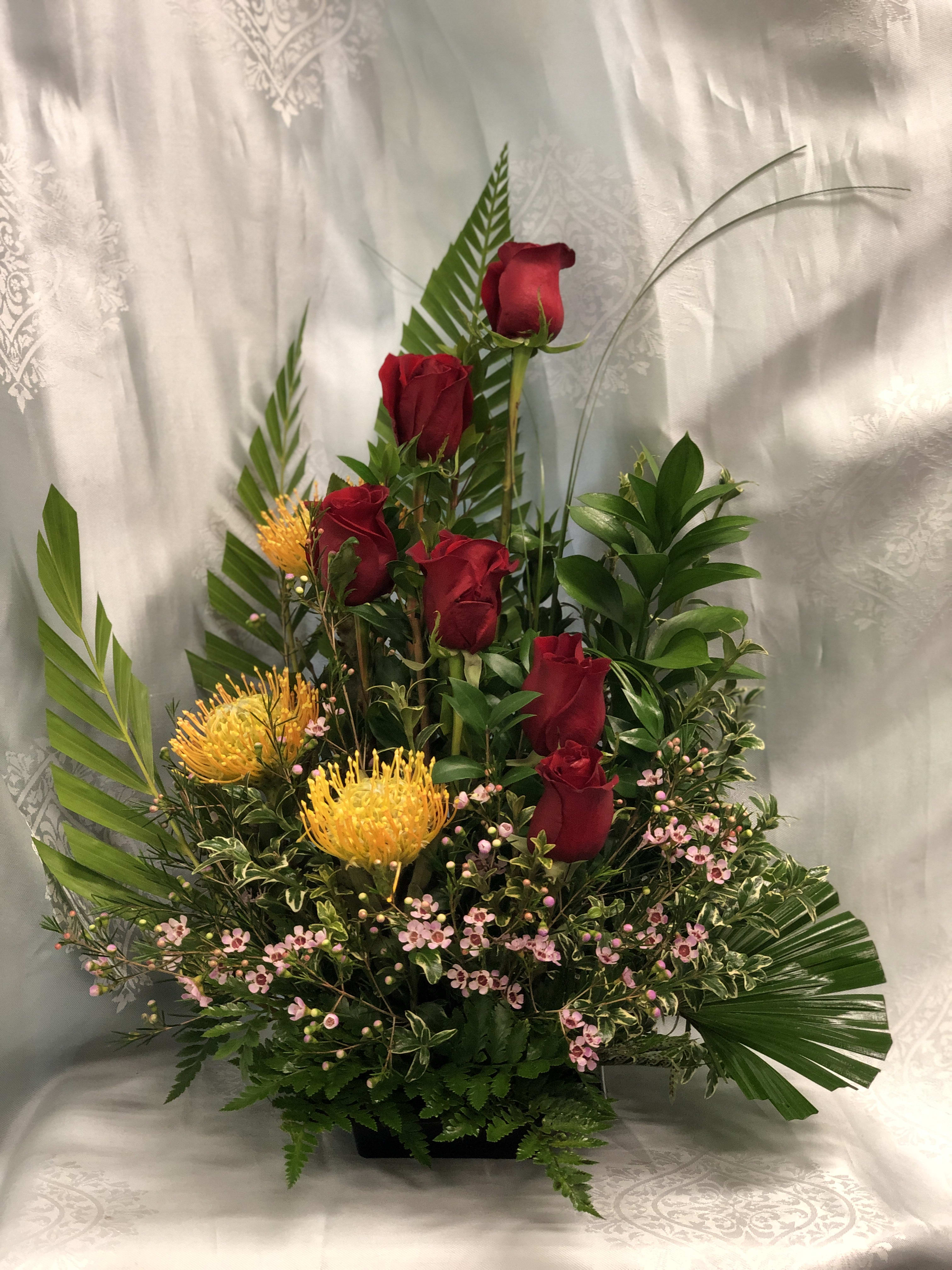 Hawaii’s Romance BQ008 -  Luscious red roses Intermingled with vibrant tropical floral surrounded by delicious pink wax flowers speak volumes of your passions for your love ones!
