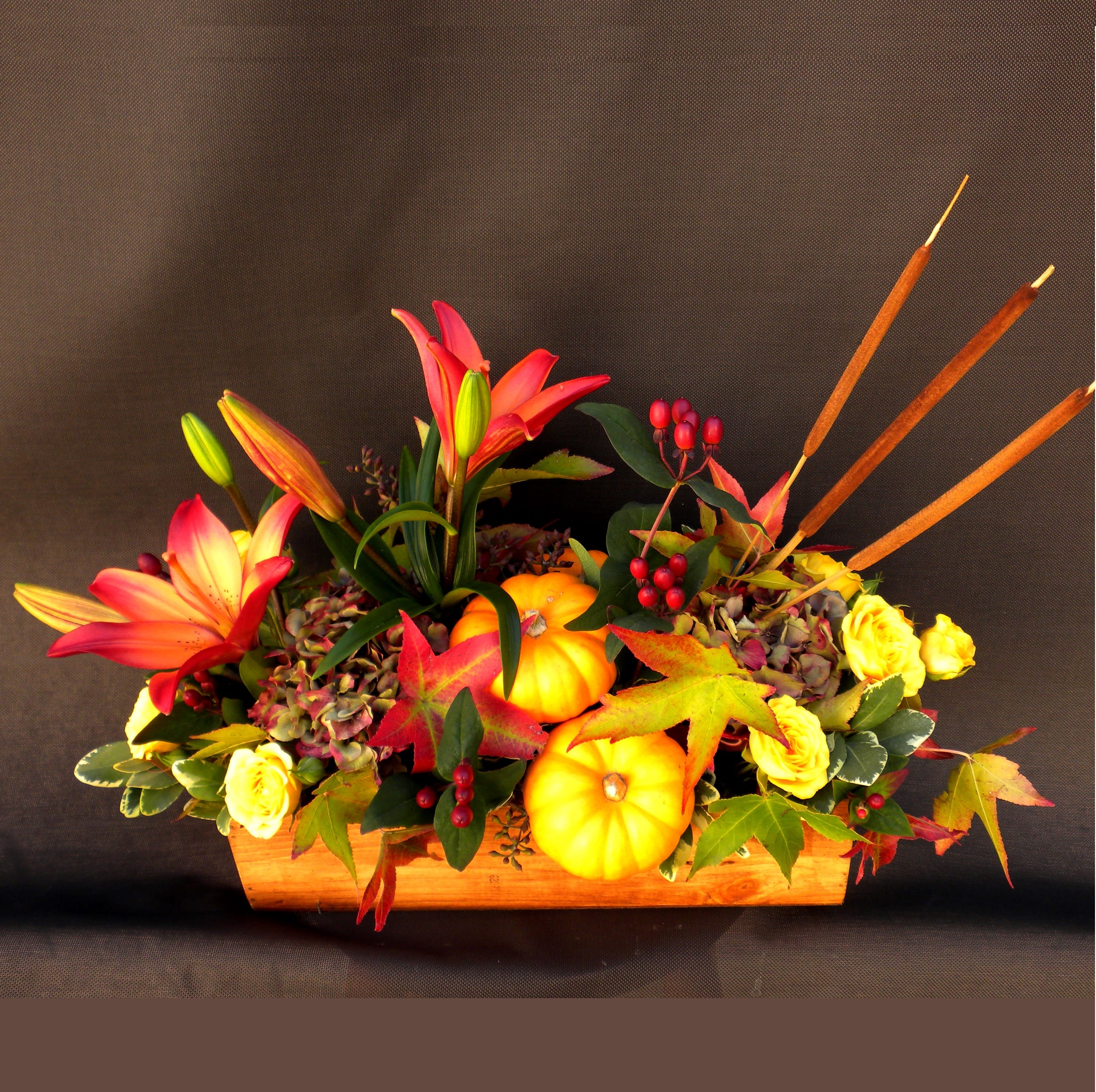 Radiant Bounty - &quot;Radiant Bounty&quot; is a vibrant fall arrangement in Danville, CA, featuring bright lilies, golden spray roses, hydrangeas, and autumn leaves, accented with pumpkins, berries, and cattails for a festive seasonal centerpiece. 