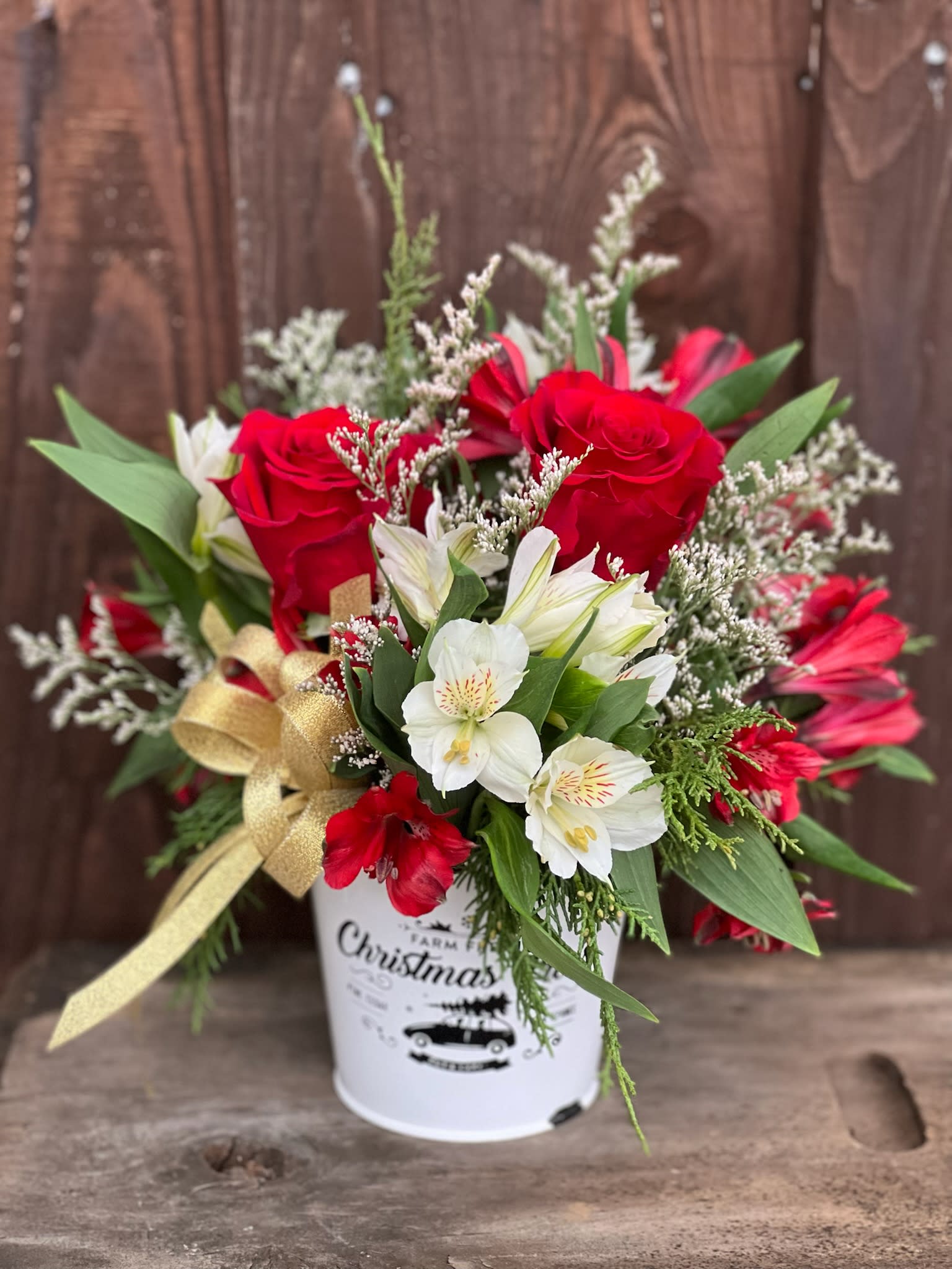 Holiday Cheer - A country tin filled with traditional fragrant pine and festive red and white blooms!