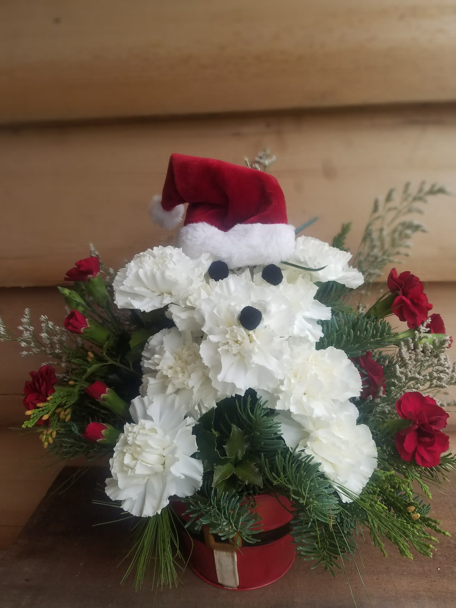 Santa Paws is Coming to Town - This adorable arrangement of Holiday flowers is in the shape of a little puppy dressed as Santa! Send some cheer and make someone smile this holiday season!