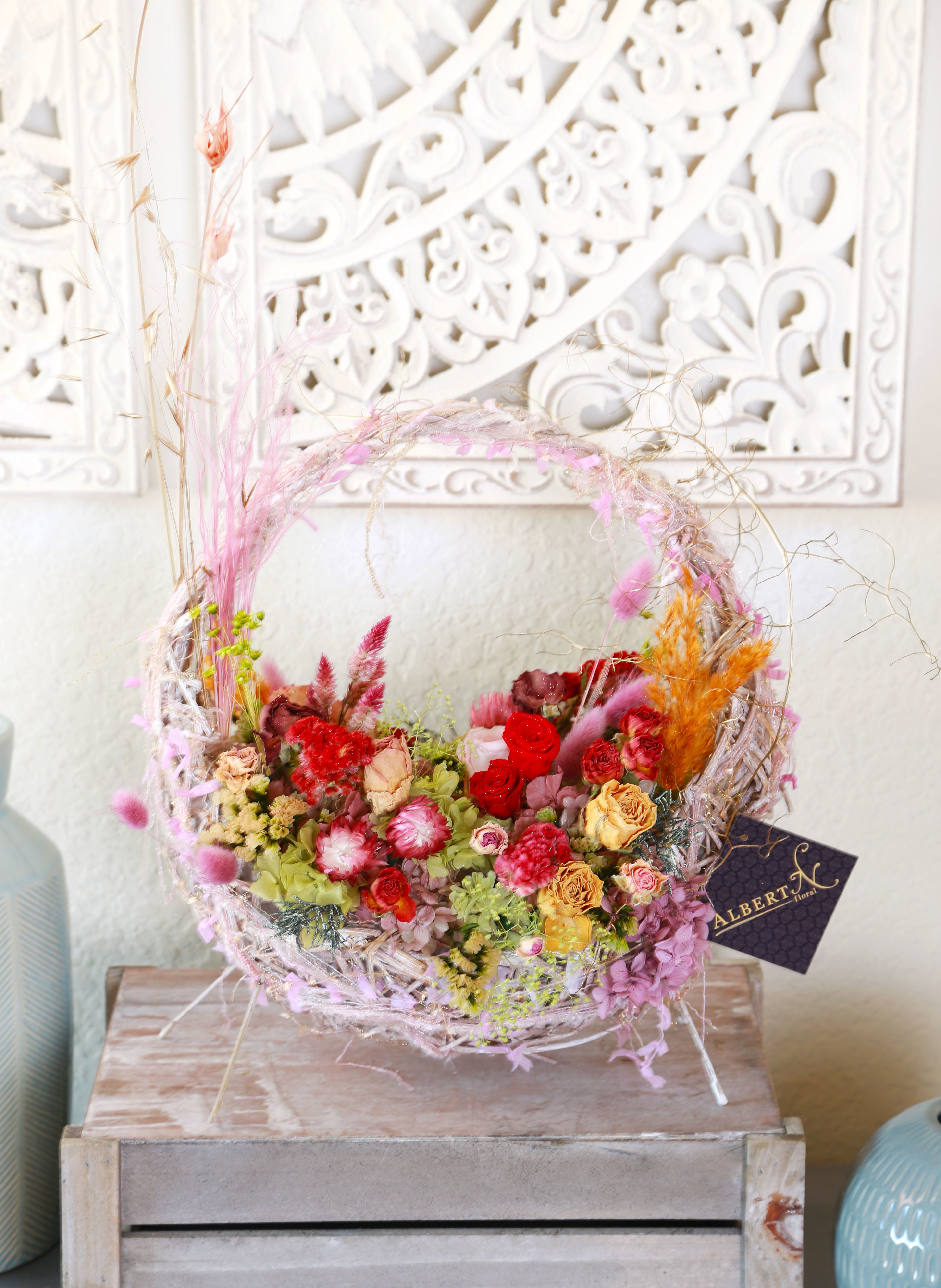 The only one - Elevate your living space with our exquisite, preserved flower arrangement, artfully presented in a charming woven basket. This stunning ubique piece features a harmonious blend of vibrant pinks, soft purples, and lush greens, showcasing an array of carefully selected blooms import from Japan, including delicate roses and whimsical dried flowers. The arrangement is expertly crafted to maintain its beauty over time, making its a perfect center piece for any occasion or a thoughtful gift for a loved one. The intricate weaving of the basket provides a rustic yet elegant touch, complementing the natural aesthetic of the flowers Whether displayed on a coffee table, bookshelf, or as part of a larger decor scheme, this preserved flower arrangement brings a lasting touch of nature indoors, enhancing your home with its delightful colors and textures. Key Features -Durable and long-lasting preserved flowers -Elegant woven basket design -Perfect for home decor and gifting -Low maintenance, no watering required Avoid put this arrangement under direct sun and handle with care. It will deliver with gift box and handwriting greeting cards. size is around 13&quot; x 13&quot; 