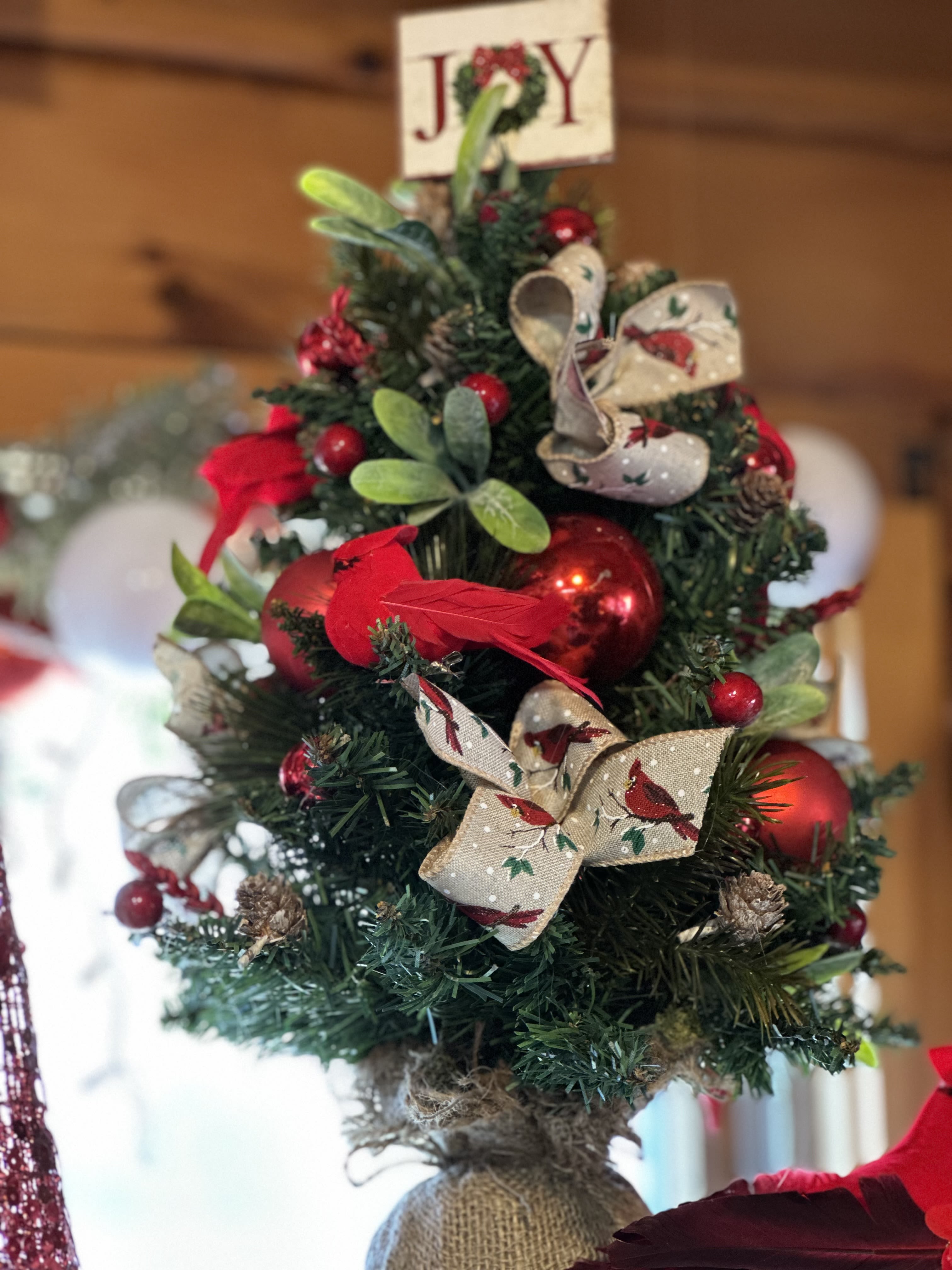 Miniture Christmas Tree - This our traditional style miniture lasting Christmas Tree, designed in red cardinals with lights, bows, balls and mixed greenery.