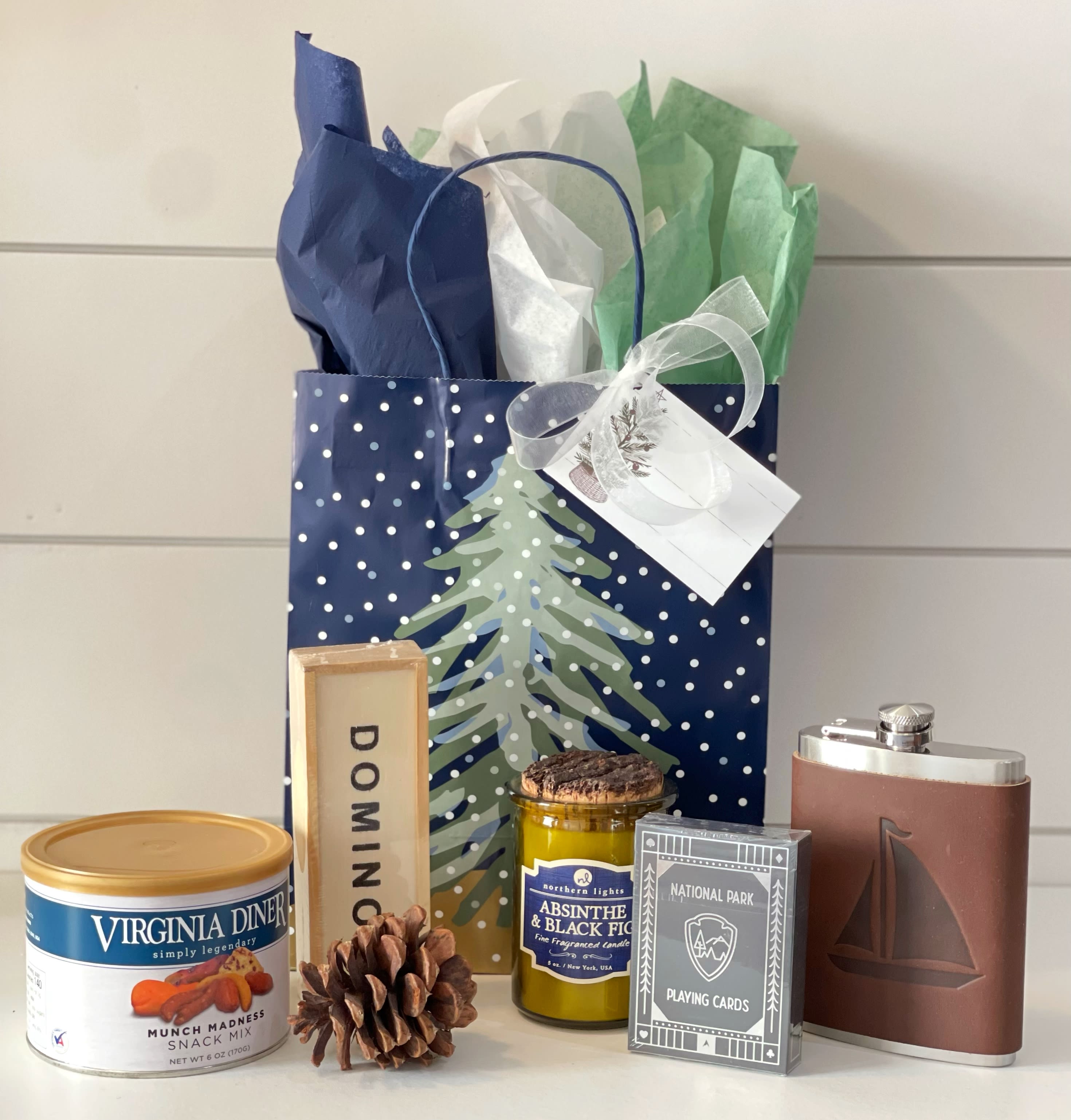 Just what HE wants for Christmas - Show him your thinking of him in ways he’ll appreciate with this masculine curated gift. -National Park playing cards -wooden domino set -Deluxe mixed nuts -Northern Lights Candle, this line combines fragrances and the wit of your favorite bartender. Fragrance notes: black fig infused with a woodsy blend of absinthe, black currant and patchouli. -Sailboat Sailing Leather Wrapped Flask hand made by Jimmyrockit. This is an 8 ounce stainless steel flask wrapped in a leather sleeve and hand stitched on the back. The flask has an attached hinged top and the leather is earthy, a perfect match. 