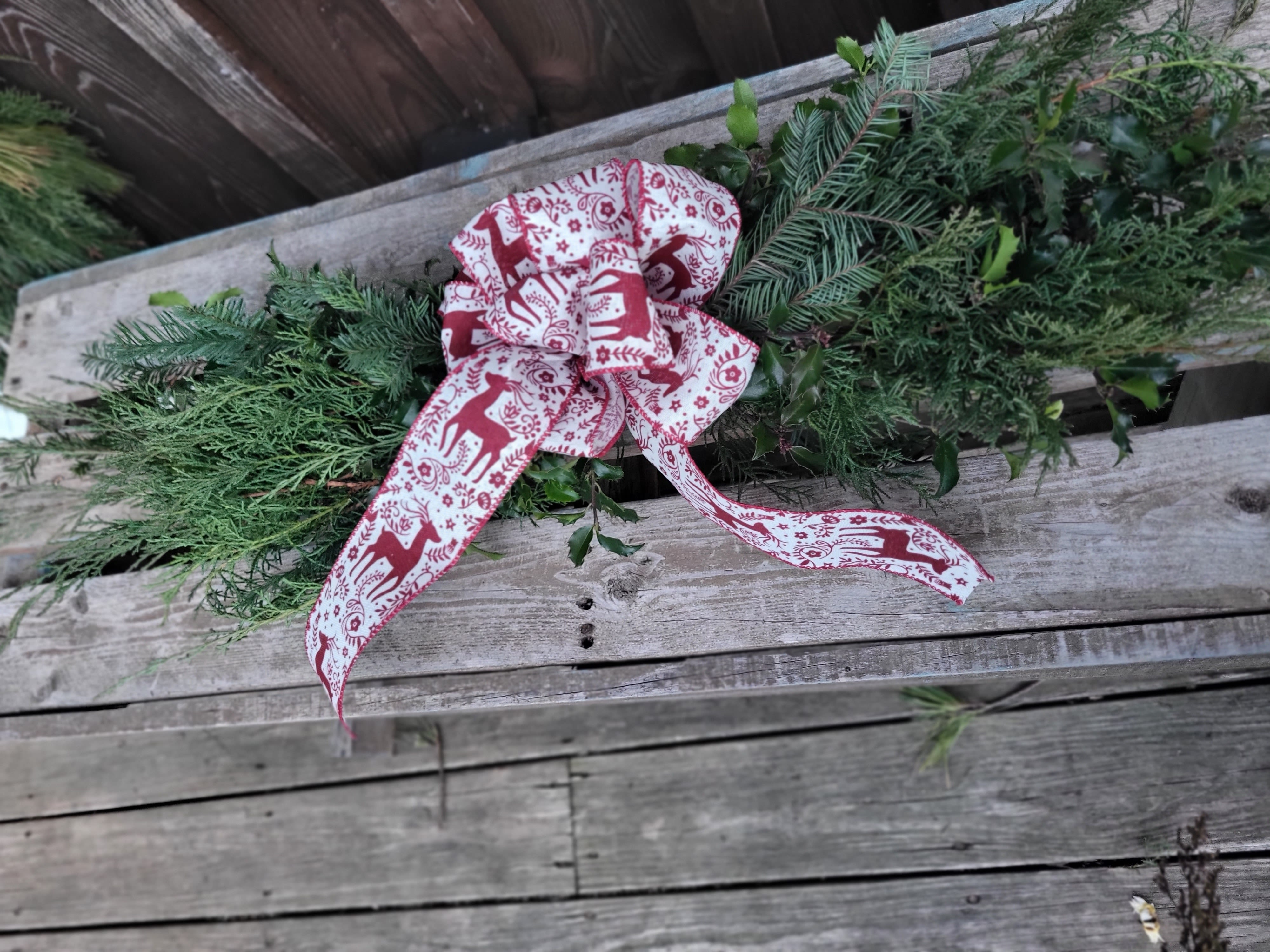 Holiday Swags - This charming arrangement features a delightful blend of fresh evergreens and fragrant pine, meticulously crafted to evoke the warm spirit of the holiday season. The centerpiece of this creation is a stunning, handcrafted holiday bow, adding a touch of elegance and festive cheer. To make this arrangement truly special, we are happy to customize the bow to perfectly match your personal style or the event's color scheme. If you have a particular color or shade in mind, please let us know, and we will do our best to accommodate your request, ensuring your chosen bow complements the natural beauty of the greens and pine.