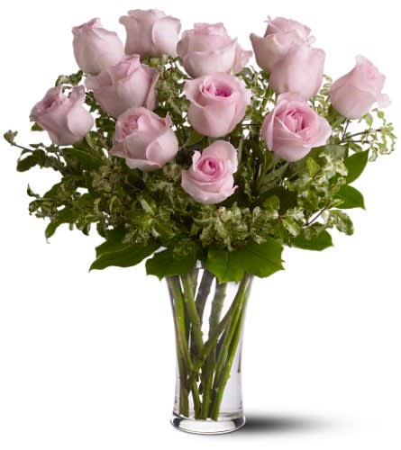 A Dozen Pink Premium Long Stem Roses - Pretty pink and perfect. There's nothing like long-stemmed pink roses to show your affection. A dozen pink roses with greens in a beautiful glass vase.