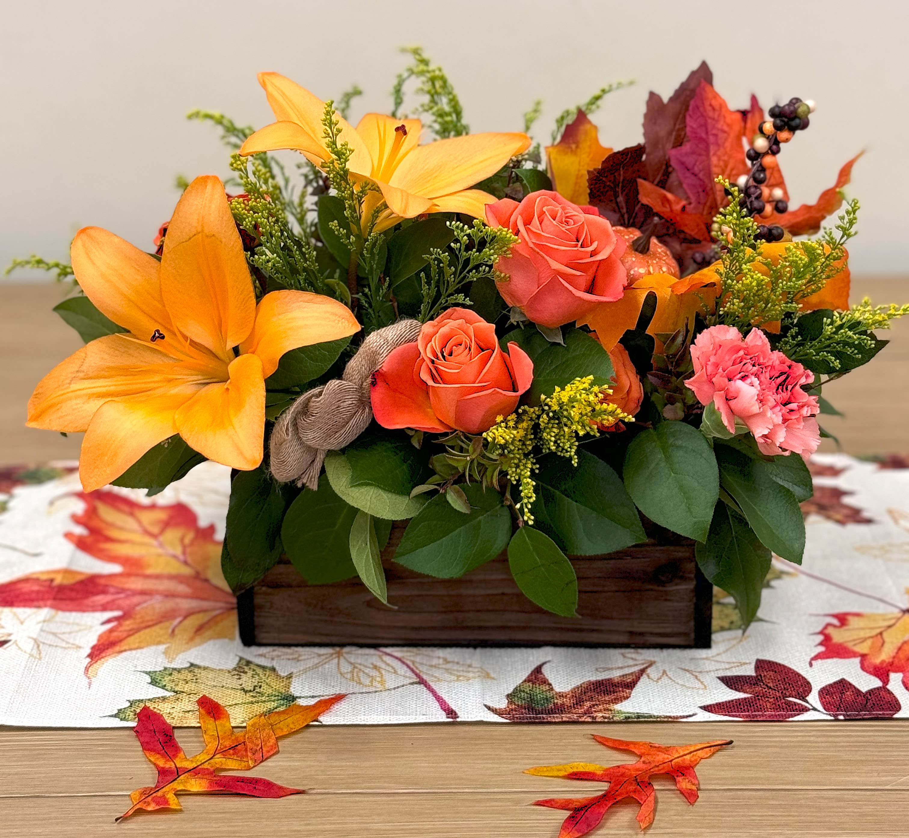 SALE!! Thanksgiving Celebrations Centerpiece (Save $10) - Bring your Thanksgiving table to life with this stunning Fall-inspired centerpiece. Thoughtfully crafted to complement your holiday feast, this arrangement blends the warm, rich hues of the season with modern elegance.  Key Features   Rich Fall Colors A vibrant medley of autumn blooms and foliage, capturing the cozy charm and beauty of the season.   Contemporary Vessel Designed in a sleek, modern container that adds a fresh twist to traditional Thanksgiving décor.   Perfect for Thanksgiving Gatherings Created to be the eye-catching focal point of your holiday table, setting the tone for a warm and festive celebration.   Versatile Placement Ideal not only for your dining table, but also entryways, consoles, sideboards, or any spot that could use a touch of seasonal elegance.  Celebrate Thanksgiving in style with this beautiful centerpiece — where Fall’s natural beauty meets contemporary design to enhance your holiday home.