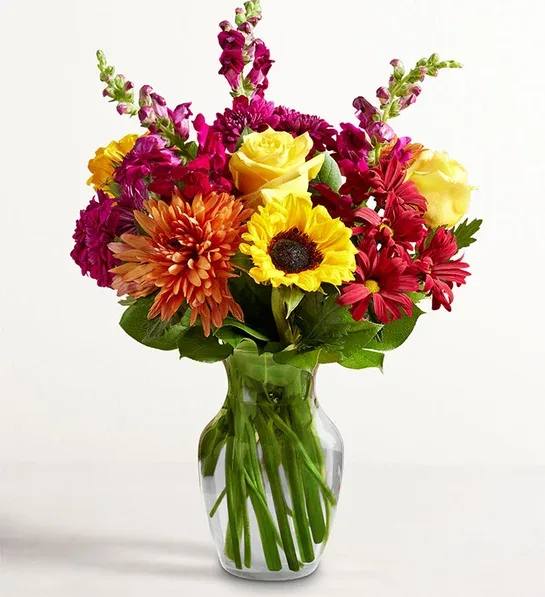 Expressions of Fall™ Bouquet - A beautiful tribute to autumn’s beauty. Our colorful gathering of blooms in radiant red, sunny yellow, and rich purple delivers the splendor of the season along with your warmest sentiments.
