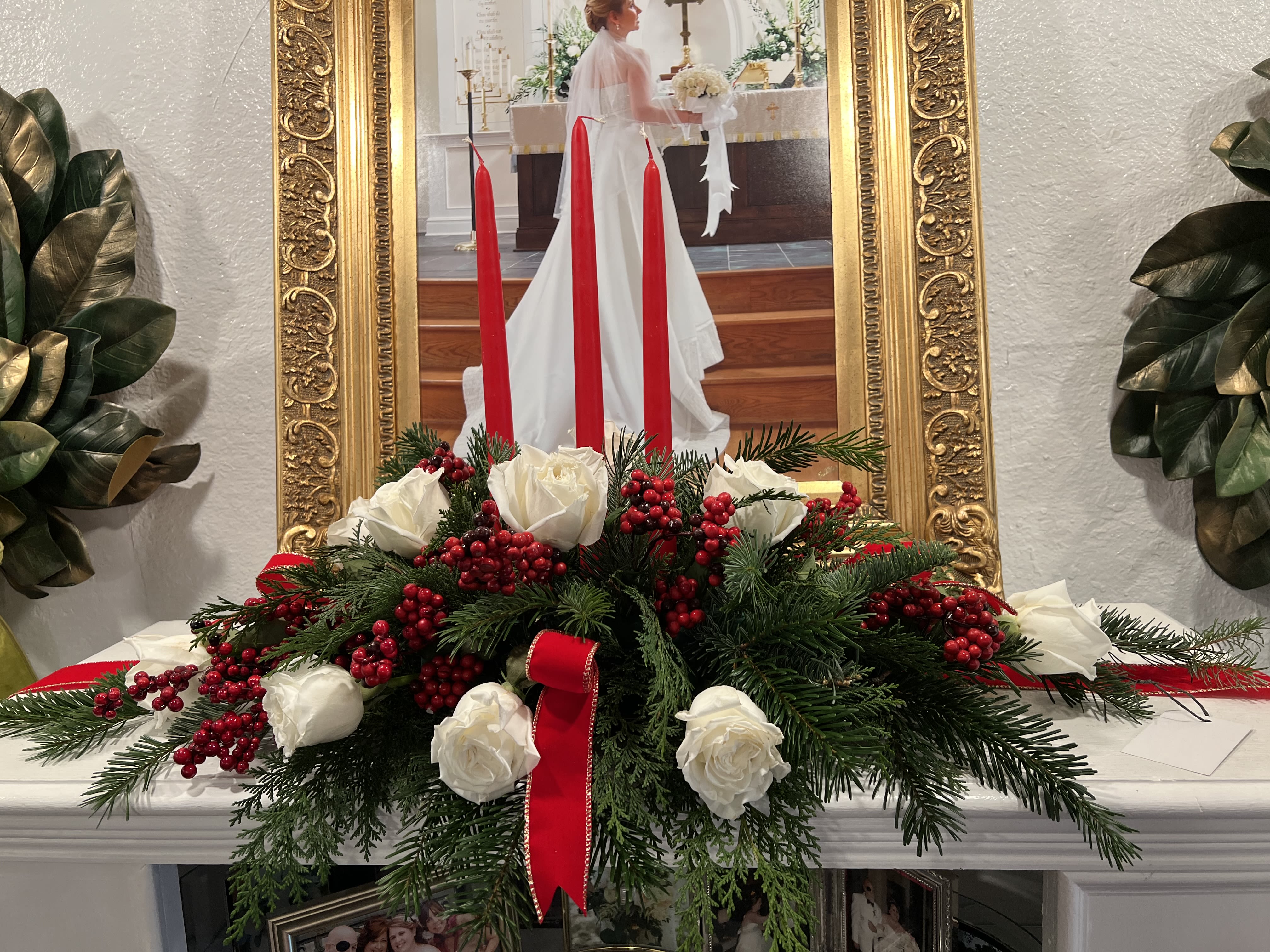 Holiday in Lights - This beautiful centerpiece which features white roses, red berries and beautiful red candles is sure to make a beautiful statement on your holiday table!