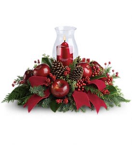 Merry Magnificence - Shiny red apples make this centerpiece a very tasteful gift. The beautiful hurricane glass and ruby red pillar candle complete the stylish arrangement!  Brilliant red berries and apples are delivered with an elegant hurricane candle, pinecones, winter greens and a stunning red velvet ribbon. It brings a lot of elegance to the table!  Approximately 23" W x 15 1/2" H  Orientation: All-Around  As Shown : T121-1A Deluxe : T121-1B Premium : T121-1C