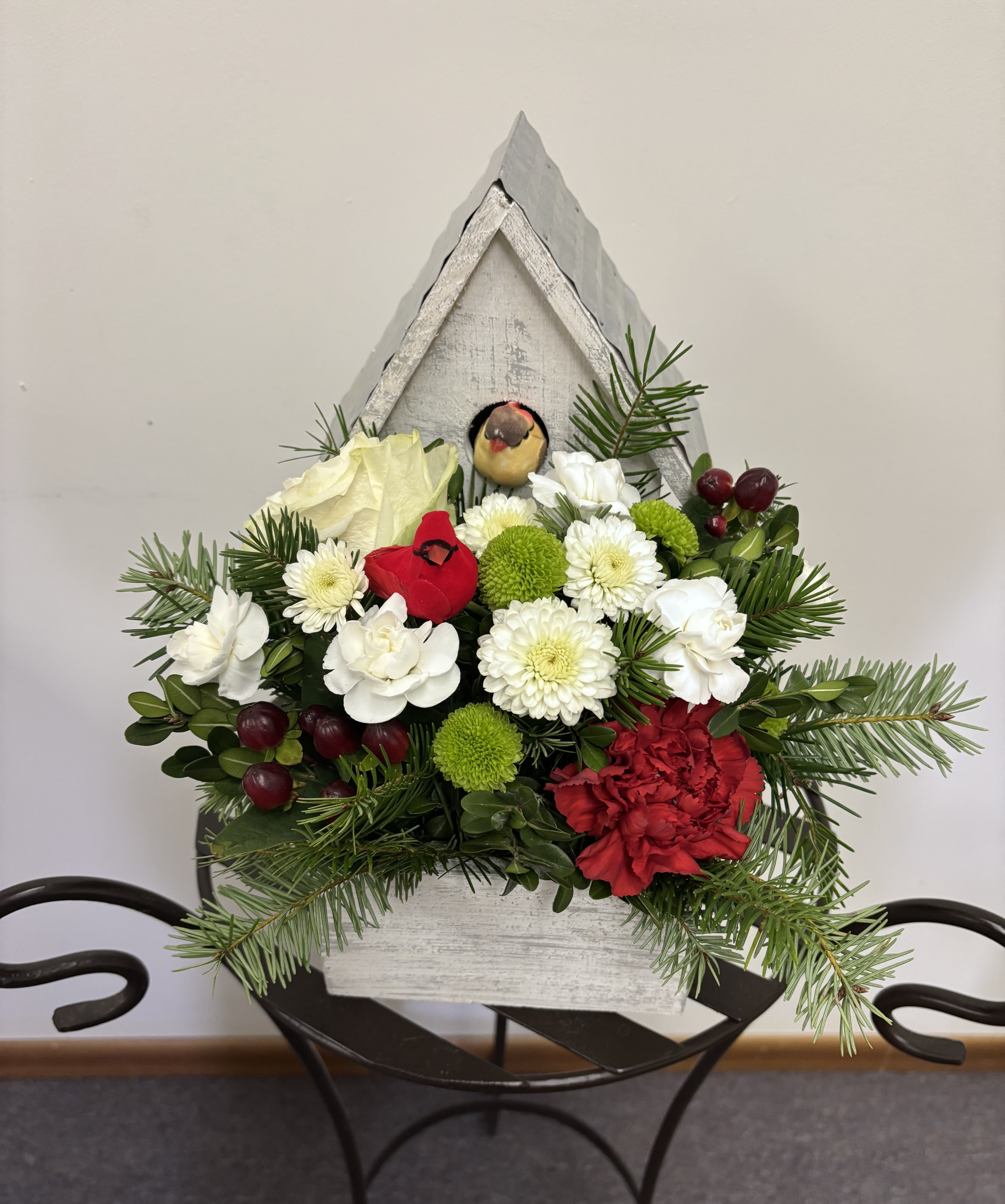 Victorian Garden - This delightfully adorable keepsake birdhouse style wooden planter is packed full of Designer chosen seasonal blooms artfully arranged with 2 coordinating cardinals perched within the arrangement. 