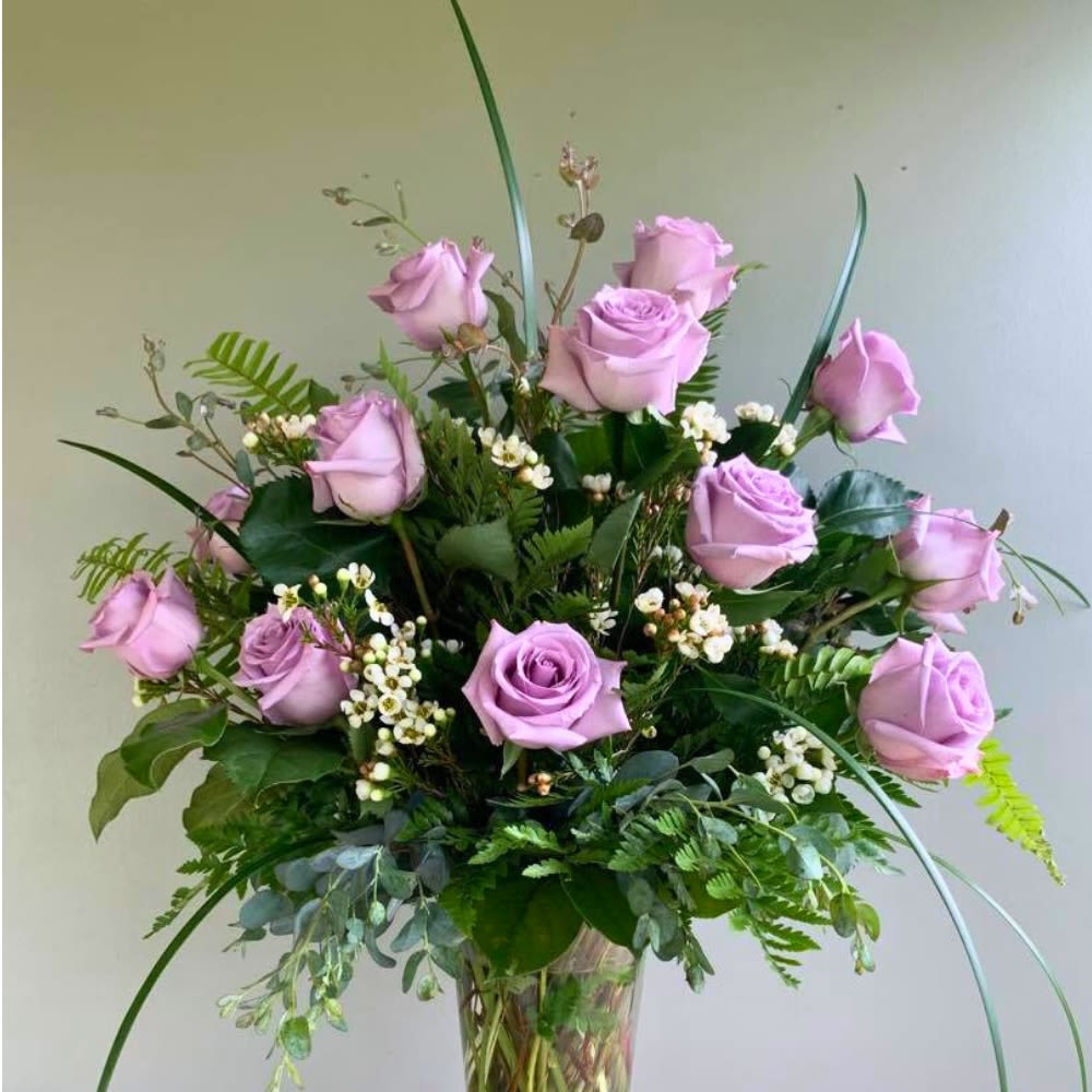 One Dozen Lavender Roses  - A dozen stunning Lavender Roses. The best gesture of love! Everyone deserves these love stems for any special day!1 Dozen beautiful Lavender Roses professionally designed with soft fillers and lush greens for a perfect presentation!  A unique arrangement hand created by our experienced designers. Please note that every design is custom made and substitution to container and flower types may happen from time to time. Design aspects will always stay the same, but if needed, we will substitute with flowers of equal or greater value to offer you a great floral shopping experience! Our flowers are 100% guaranteed. Please call us with any questions or concerns.