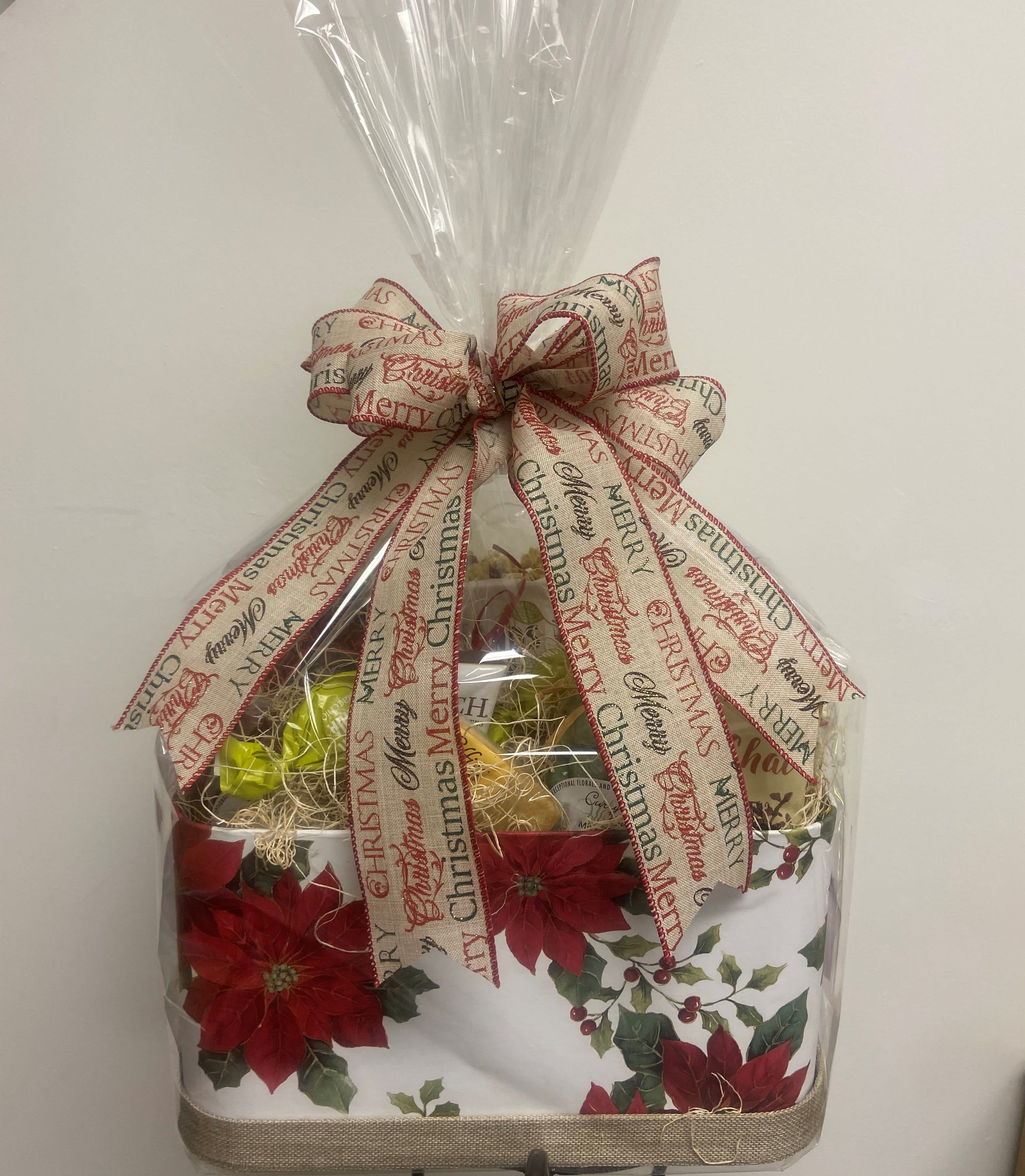 The Ultimate  Delight Gift Basket - We use only the finest high quality "stand-alone" items in our custom designed gift baskets, not standard gift basket "fill." Each stellar item is hand selected from vendors across the US each season to create baskets that are truly the "Best of the Best!" Each basket may  feature selections from the following items: Artisan Chocolates, Biscotti,  cookies, Popcorns, Toffees , chocolate pretzels, Chocolate covered items, chocolate spoons, coffees, teas, snack mixes, nuts, etc etc... In each basket we hand select from these listed items and more to create a delicious and upscale treat extravaganza in the price range you have selected! (Designer may substitute an equivalent or more valuable item or include items not listed here due to availability.) The container is either a basket, a holiday decor box or tin....all items that can be kept by the recipient as a remembrance and repurposed in their household. Items in the basket are based on seasonality/availability. Item pictured is the $100.00 size option.  Your delivered item will be similar in size but may be in a different container and be custom created from items other than those pictured.  Container is approximately 14" x 10".