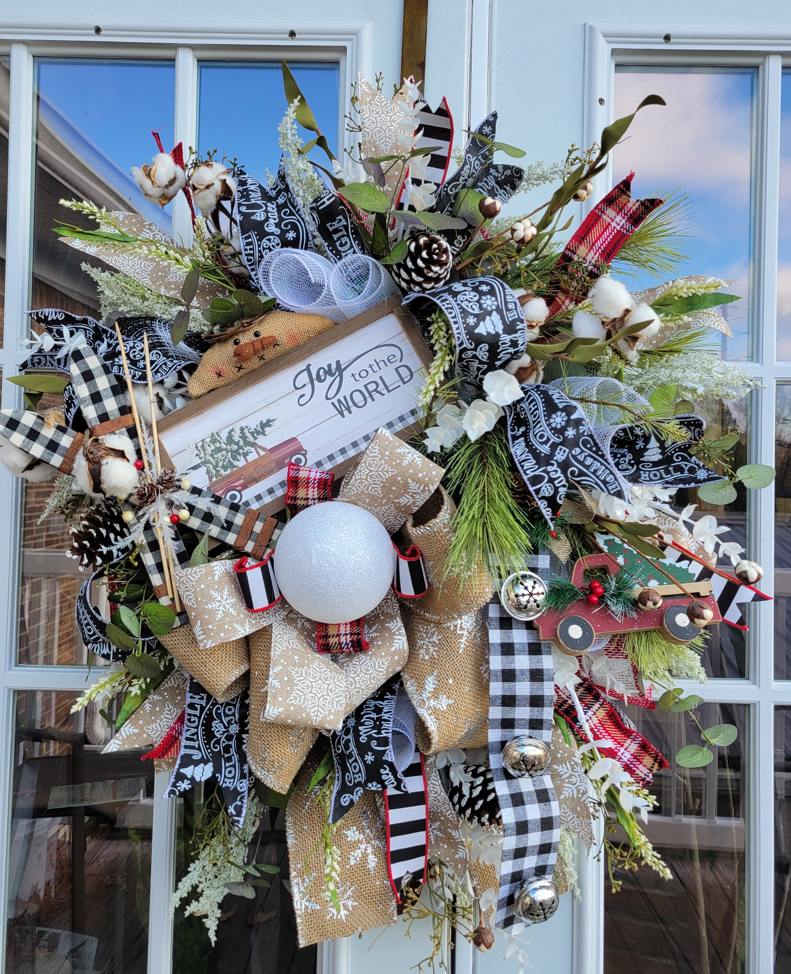 It's Snowing Cotton Wreath - Wreath on a deco mesh base decorated with pine greenery, cotton, red truck ornaments and sign accented with black and white ribbon. This wreath could stay up through the winter. Retail price $85 SALE! $42.95