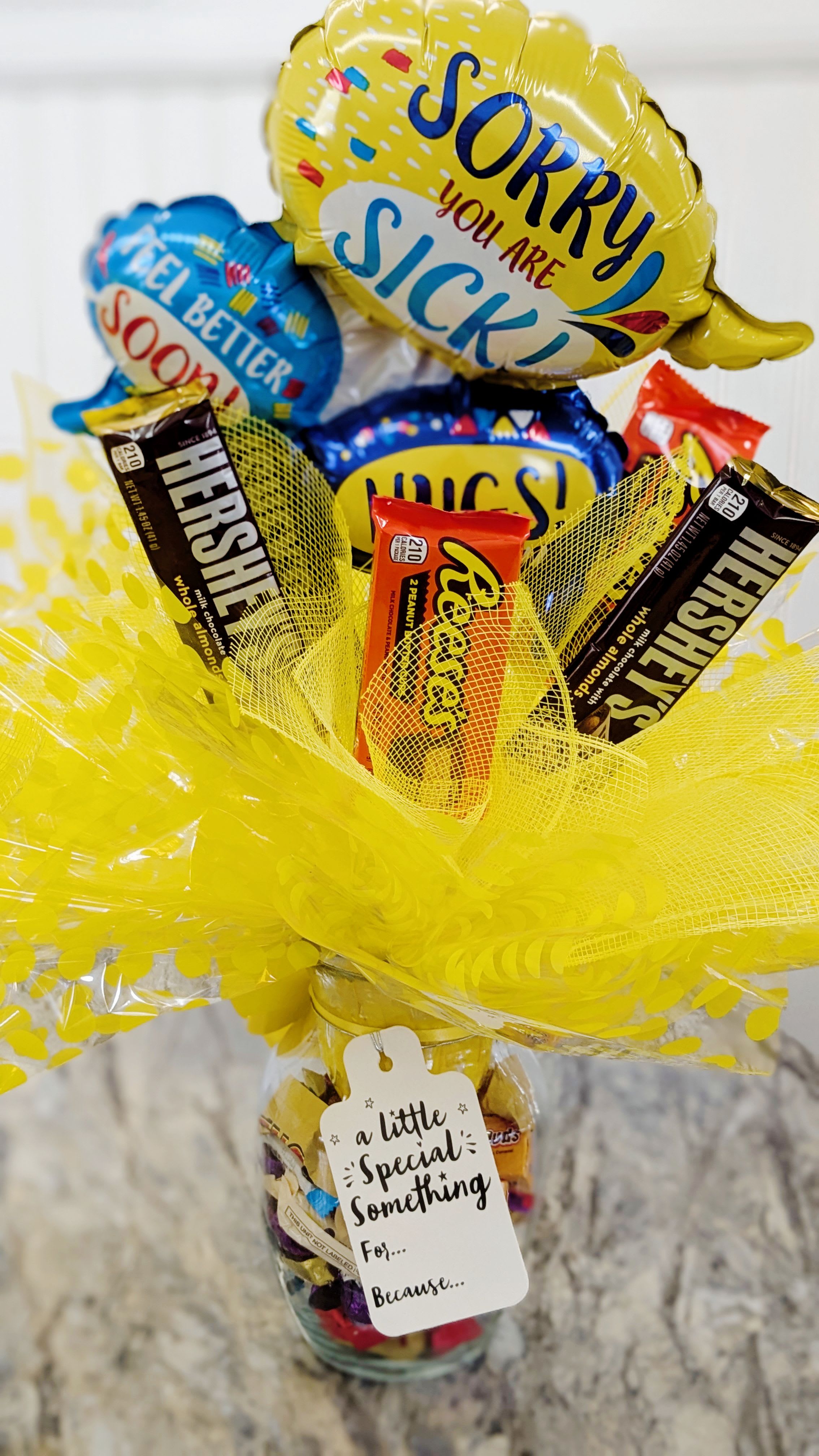 Get Well Candy Bouquet  - A vase filled to the brim with delicious bite sized candy. Topped with full sized candy and a Balloon. Bound to bring a smile to anyone's face. *candy subject to change, please leave a special instruction if PEANUT ALLERGY*
