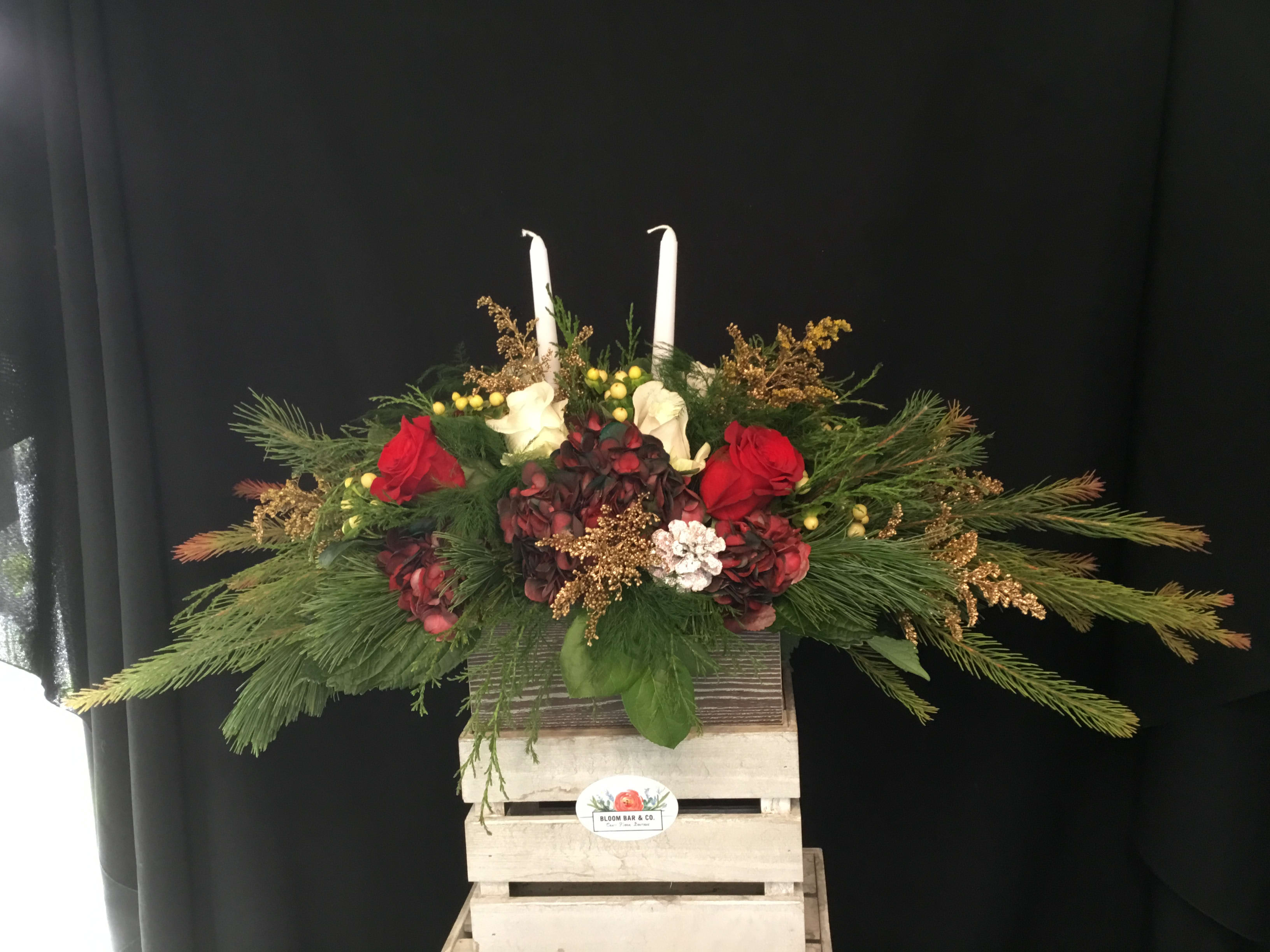 Festive Candlelight Centerpiece - You're really going to show someone you care with this masterful centerpiece. It is a low-lying arrangement, so that you can still enjoy your friends' company over the flowers on the table!