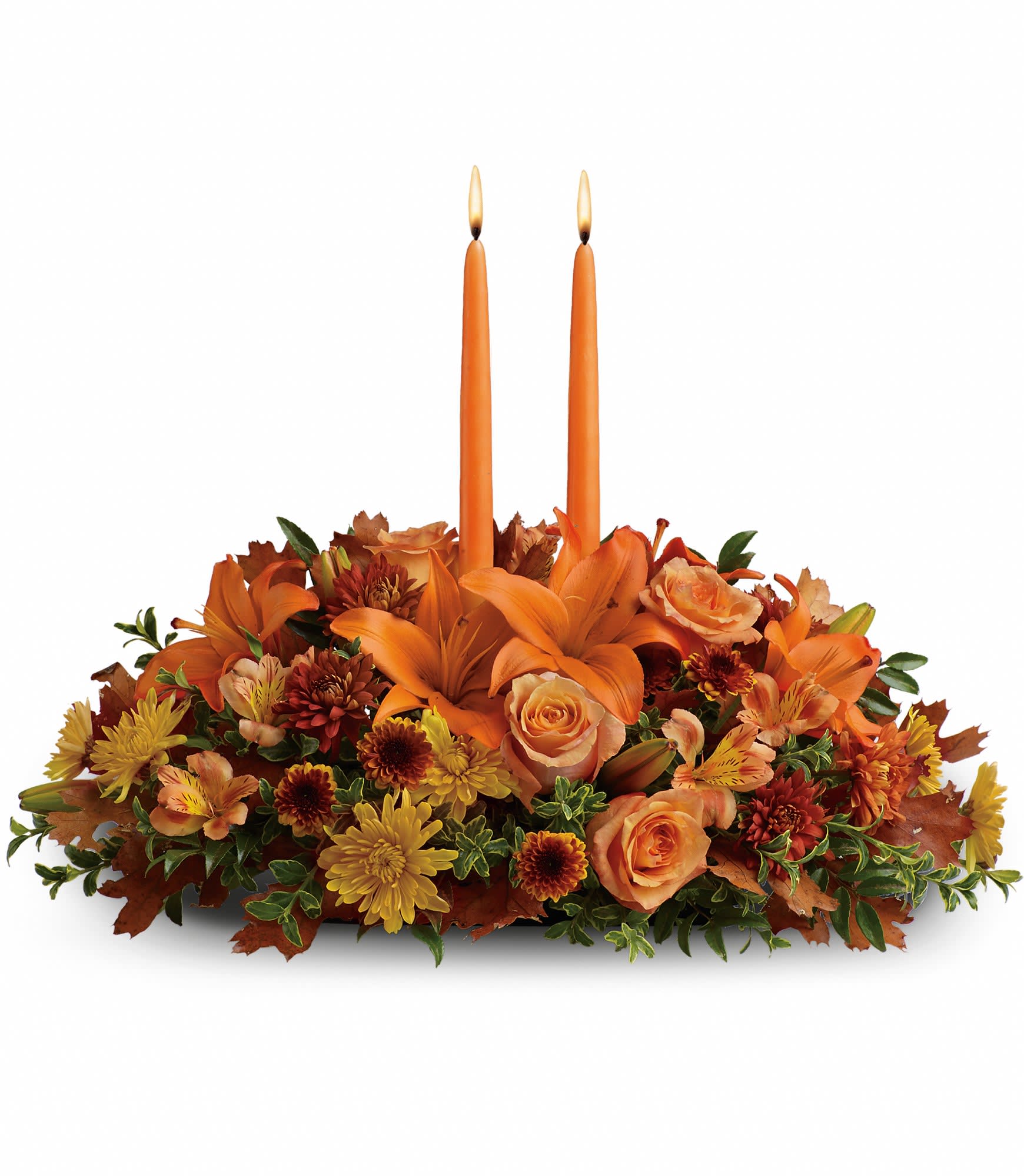 Family Gathering Centerpiece  - As your loved ones gather around the table, they'll bask in the warm glow of two orange taper candles surrounded by a fantastic array of fall flowers. Orange roses, asiatic lilies, dark orange alstroemeria, bronze button spray chrysanthemums, yellow and rust cushion spray chrysanthemums and fall foliage are exquisitely gathered in this center-of-attention piece. Approximately 23" W x 16" H