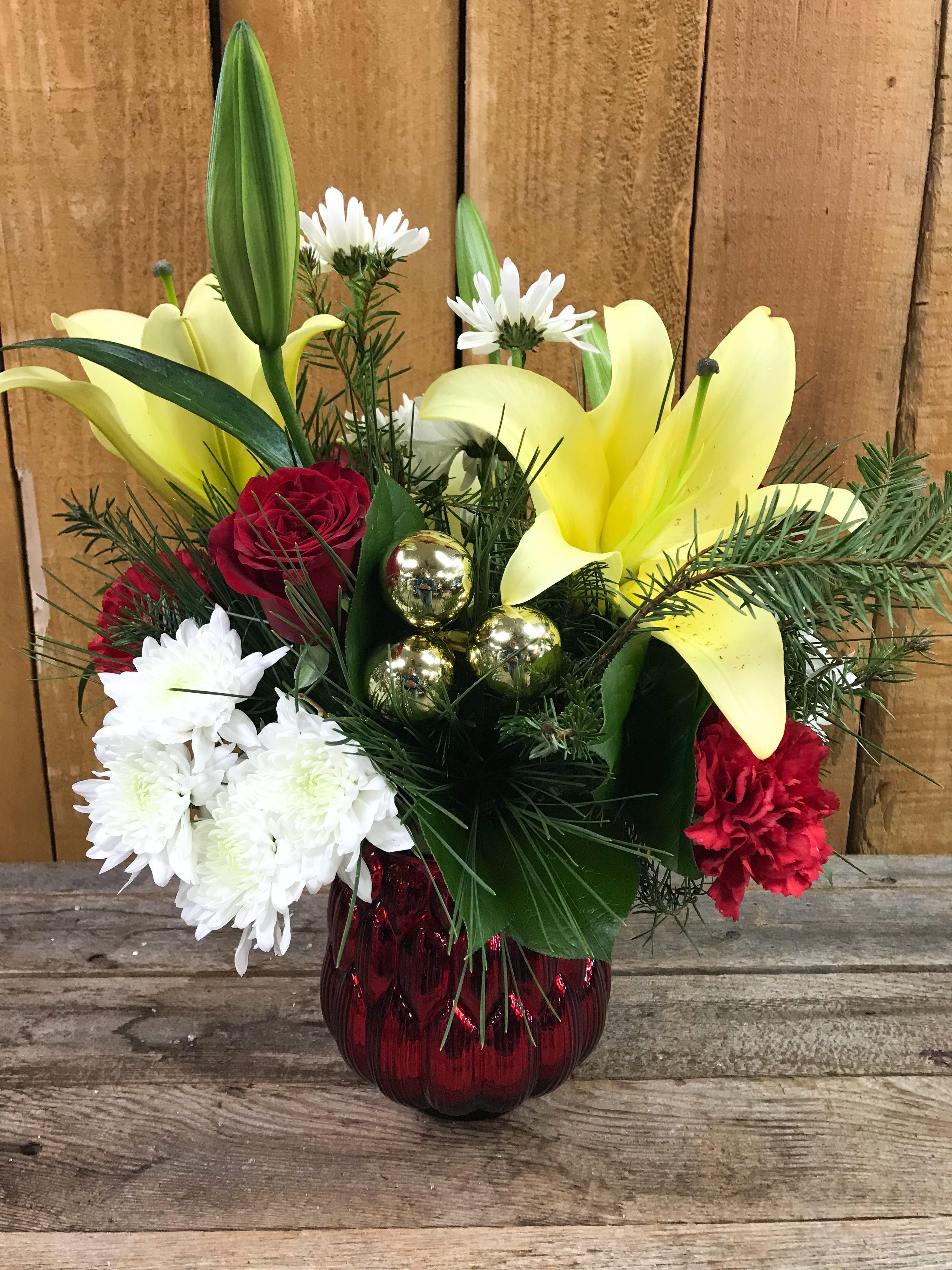 Holiday Cheer Bouquet - Find some holiday cheer in this colorful holiday arrangement, with yellow lilies, red roses and carnations, and white accents. 