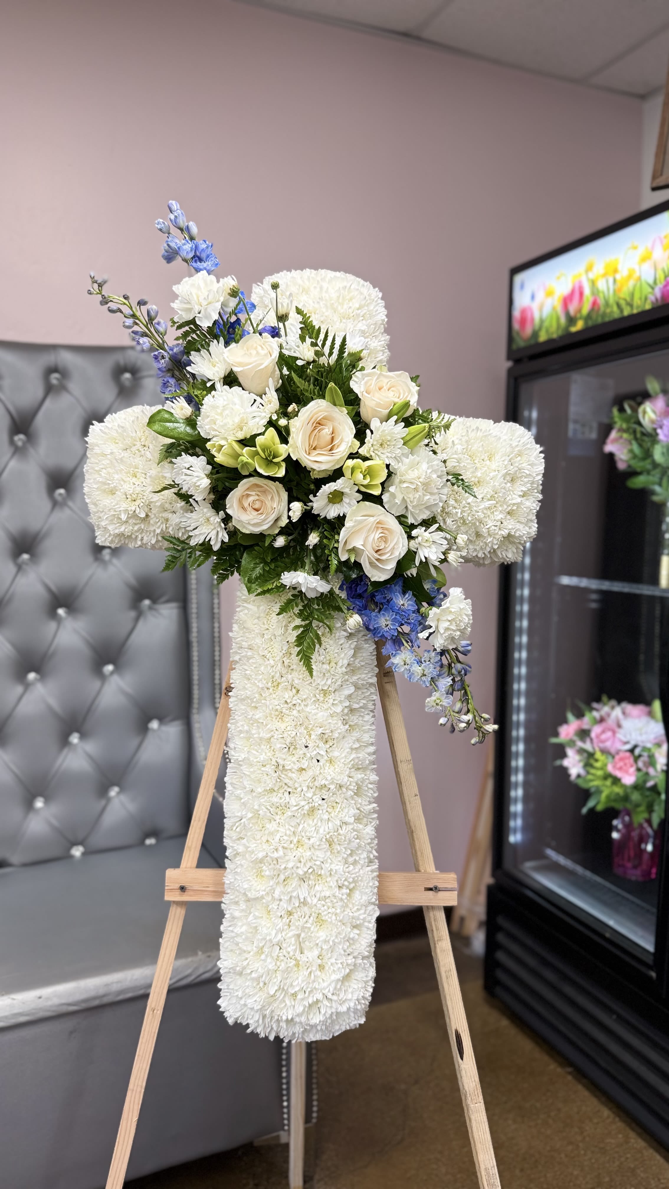 PEACEFUL MEMORIAL CROSS - Measures approximately 36" in height and includes a 6-ft easel. Features white flowers with subtle blue accents.