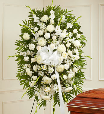 Deepest Sympathies White Standing Spray - White flowers are often sought after as symbols of honor, reverence and remembrance. This striking standing spray exquisitely crafted by our expert florists from an assortment of pure white blooms is the perfect expression of all the love, compassion and support you feel during their time of mourning. Standing spray arrangement of fresh white roses, carnations, snapdragons, football mums and more Appropriate for family, friends or business associates to send directly to the funeral home.