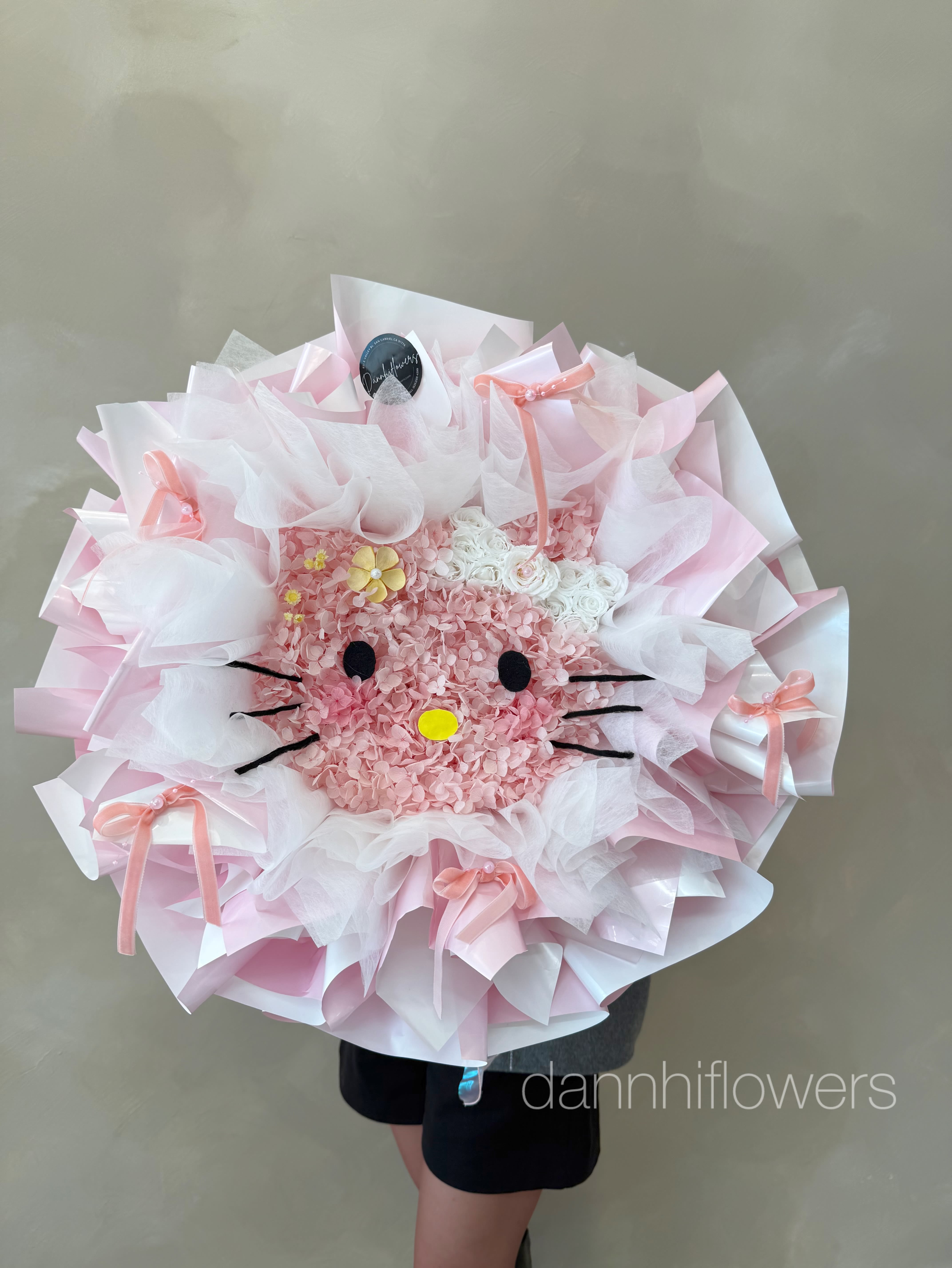 Sweet Kitty Blooms Dried Flowers - A unique Hello Kitty Bouquet total handmade with love and care.  Discover the beauty of long lasting blooms with our Dannhiflowers Dried Flower Collection. Each bouquet is thoughtfully designed using premium preserved botanicals, soft textures, and timeless color palettes to create an arrangement that stays beautiful for months or years.  Perfect as home décor or a meaningful gift, our dried bouquets offer effortless elegance with no maintenance required. Whether you prefer romantic tones, modern pastels, or bold statement colors, every piece is handcrafted with care and styled in our signature wrapping for a polished, luxurious finish.