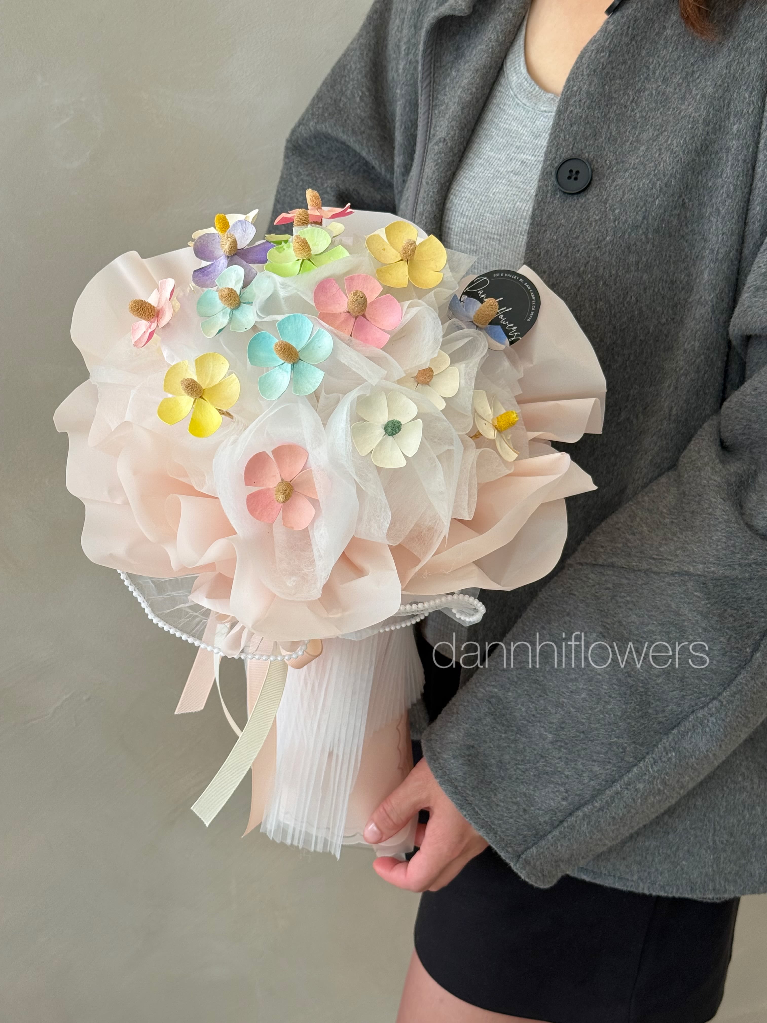Candy Garden Dried Flowers Bouquet. - Candy Garden Bouquet Dried Flowers.is a sweet and whimsical arrangement featuring hand-crafted pastel flowers in soft rainbow hues. Designed with airy layers of blush wrapping and delicate textures, this bouquet brings a playful yet elegant charm to any space. Perfect for birthdays, thankyous, or simply brightening someone’s day, this long-lasting dried bouquet adds a cheerful pop of color that never fades.