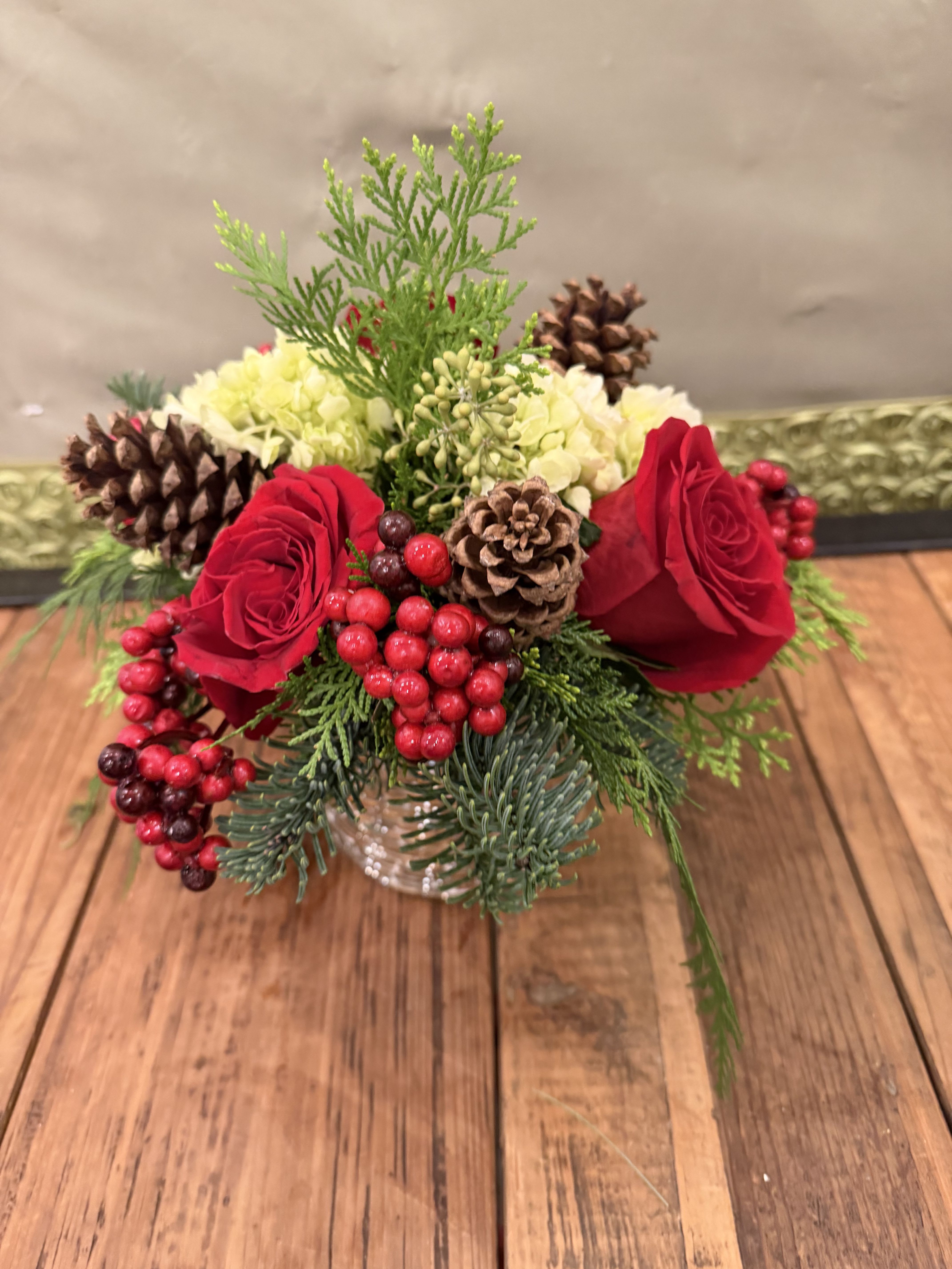 Merry Mosaic - This beautiful floral design features beautiful red roses, mini green hydrangeas, Christmas greens and accents in a gorgeous silver and gold mosaic style container. It is sure to add that extra sparkle to any Christmas gathering!