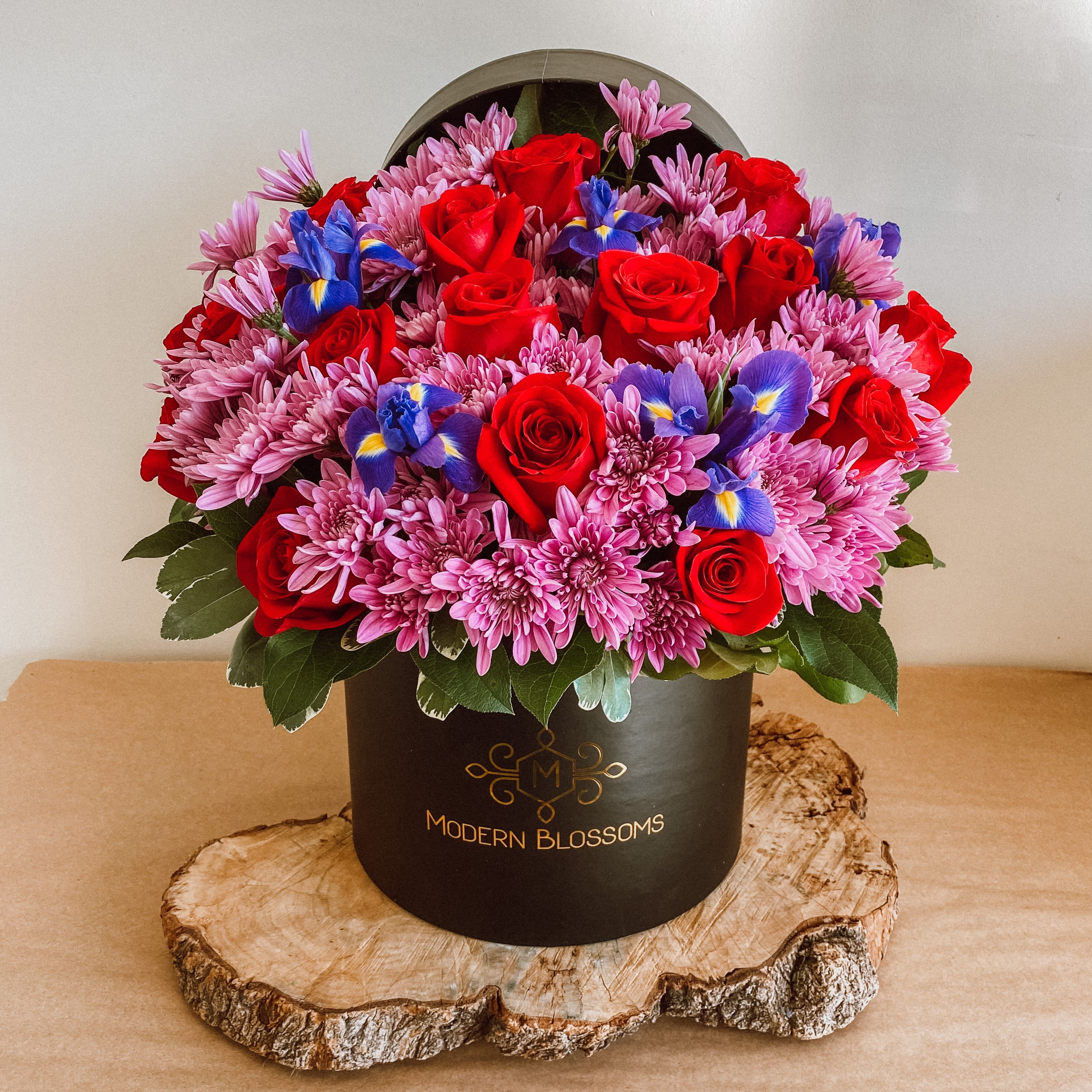 Foreve Mine - Will you be Forever Mine ??The hints of red roses are classic within these mums that symbolize optimism, joy, with faith and hope of these blue iris. This arrangement is the perfect gift to show that forever love to someone special.; An arrangement Roses, Iris, and Mums in a cardboard box.    Substitution may occur  Occasionally, substitution of flowers, plants, or containers may occur due to local and seasonal availability. We take the utmost care to ensure the same style and color scheme of the arrangement is maintained using similar items of equal or greater value.  The Arrangement and ;Vase may look different   The arrangement that is delivered contains the same number of flowers but they are arranged throughout the entire vase. The vase shown may be out of stock, and we will replace it with ;similar ;vase.;For the arrangement the look, style and color may be different from what is pictured.  To ensure the freshest flower delivery, certain flowers may arrive in their bud stage. This increases your flowers’ shelf life so you can enjoy them longer. Please allow 2-3 days for the flowers to reach full bloom.