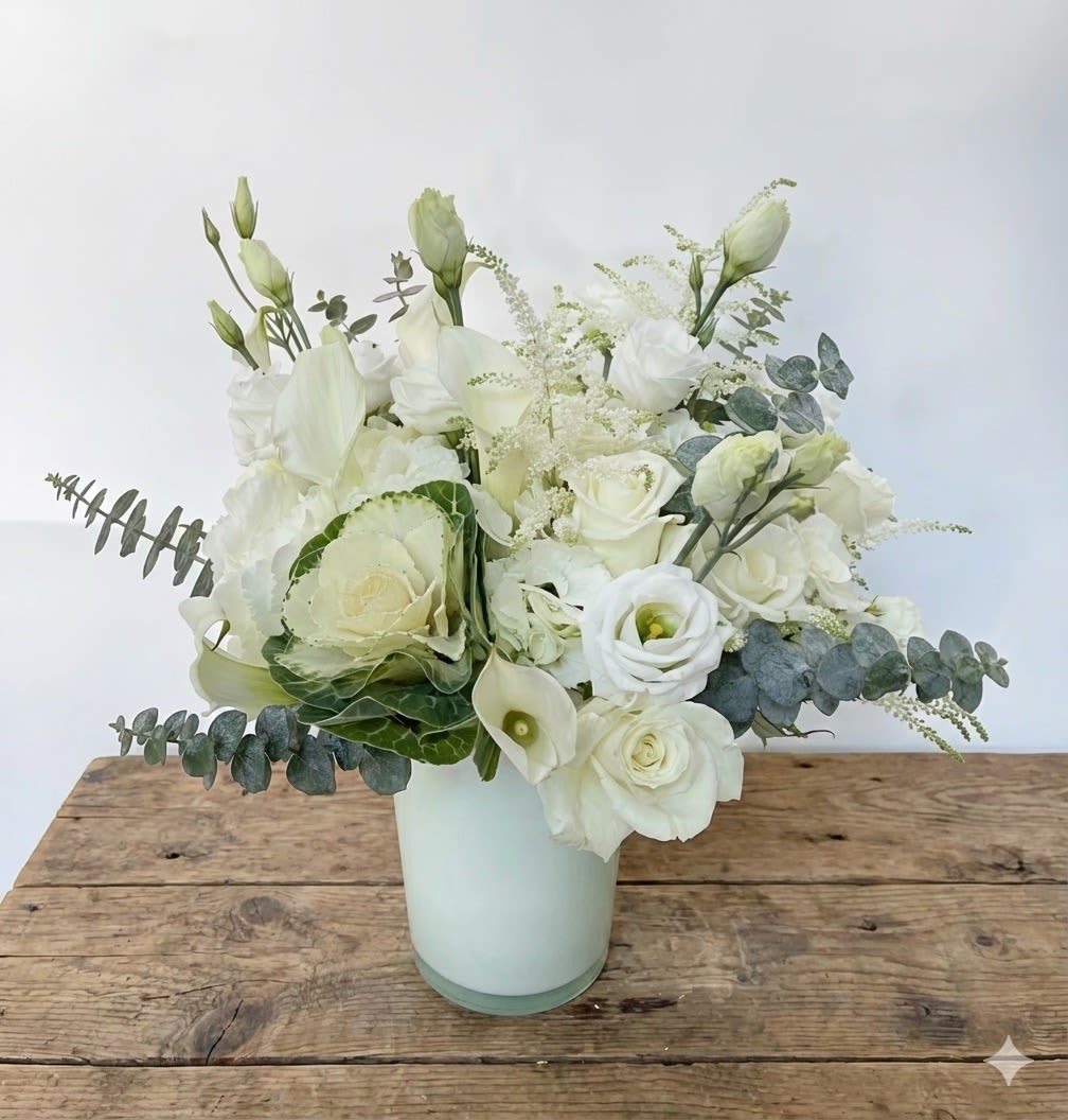 Chic Lady - This white and green arrangement includes white hydrangeas, green hydrangeas, white roses, white calla lilies, white lisianthus and other white/green flowers. 