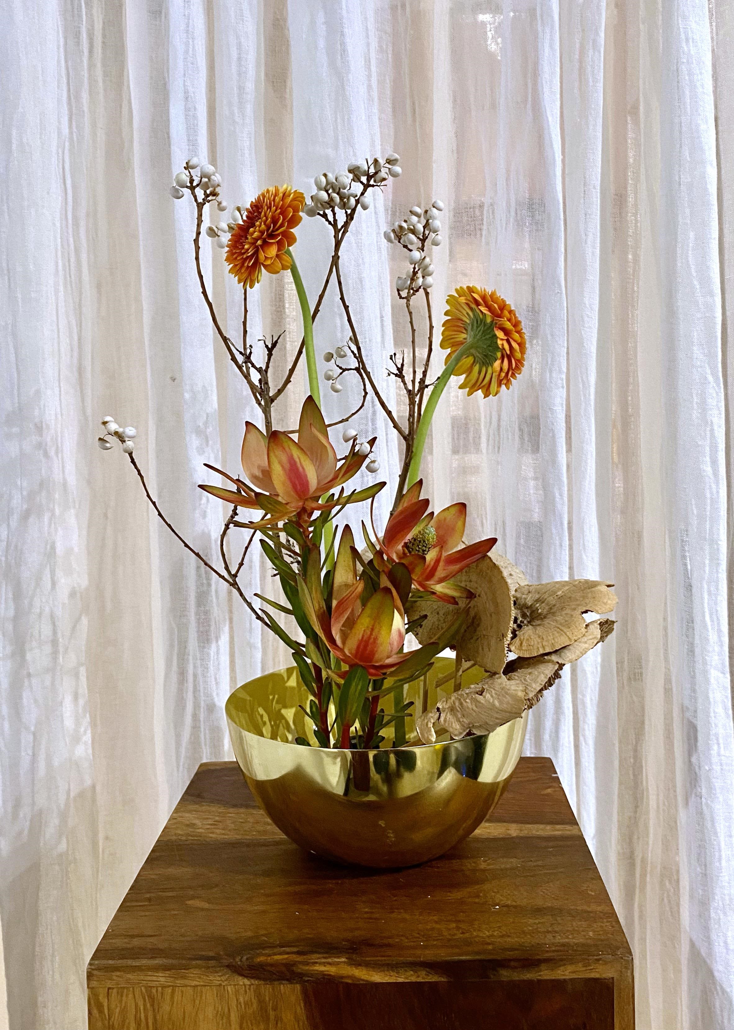 Whimsy Ikebana - A whimsical assortment of festive blooms, unique fillers, and dried goods. A more unique, artsy arrangement than your typical delivery arranged in the style of Ikebana. Drop a note for a bit of direction or let our designers flex their talents. A mix of designer’s choice white and tan blooms of Lisianthus, Mum, Rose, Alstroemeria, Hydrangea nestled in assorted greens and Eucalyptus. 