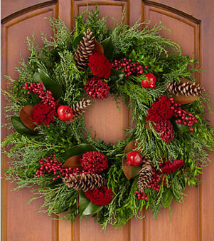 Yuletide Greetings Holiday Wreath (Wanting a custom color of Holiday trim just ask!) 3 TO 4 DAY NOTICE REQUIRED - The Yuletide Greetings Holiday Wreath has a rich and elegant look that will be the perfect touch to your holiday decor. Bringing together lush green magnolia leaves and silver hued cypress stems to form the base, this Christmas wreath is then accented with red yarrow, red magnolia pods, and red pomegranates to create that perfectly stylish holiday look. A wonderful way to greet your yuletide guests when hung on your own front door, this fresh wreath also makes an excellent gift for friends and family near and far, helping them embrace the joy of the season with it's classic Christmas style. Wreath measures 20-inches in diameter. Do not place in direct sunlight as the coloring may fade. Your purchase includes a complimentary personalized gift message.