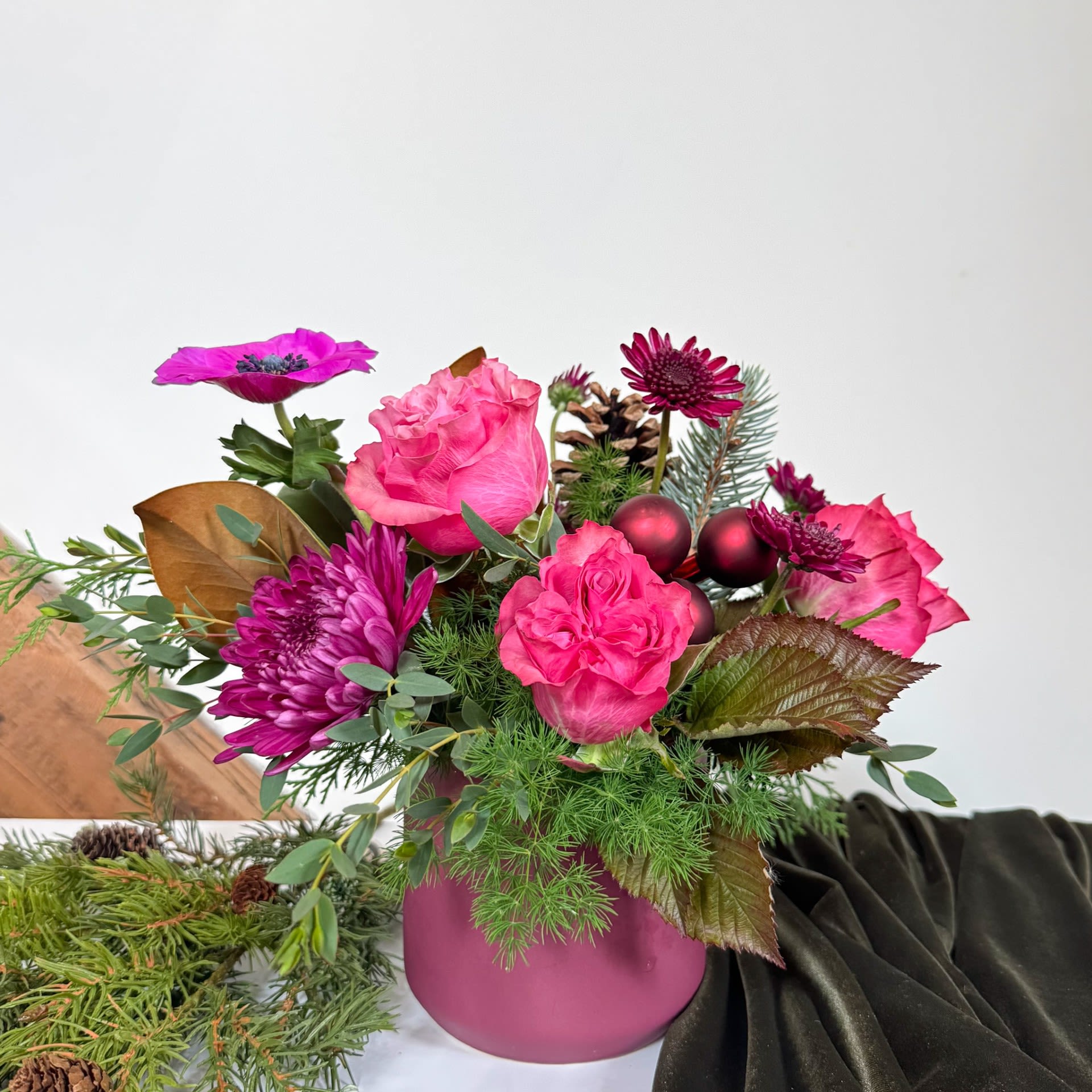 Sugar Plum - This cheerful variety of flowers is appropriate for all occasions. Sweet plum hues with pinks and purples to balance in a ceramic container. Measuring approximately 8 x 14. Upgrade for additional premium blooms.