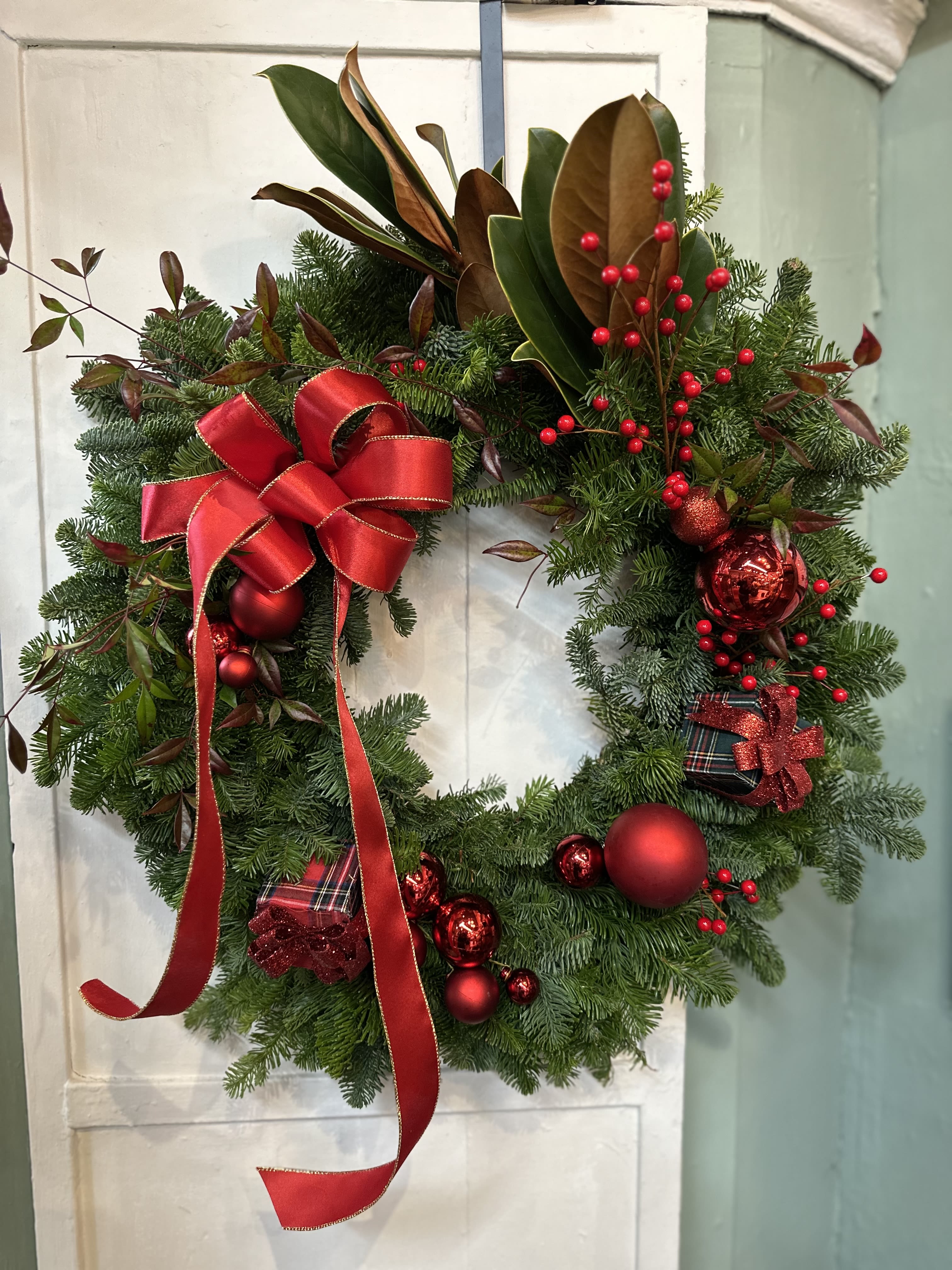 Home for the holiday Wreath - Custom designed fresh evergreen wreath 26&quot;, featuring a festive bow, magnolia leaves, berries and other assorted holiday elements. 