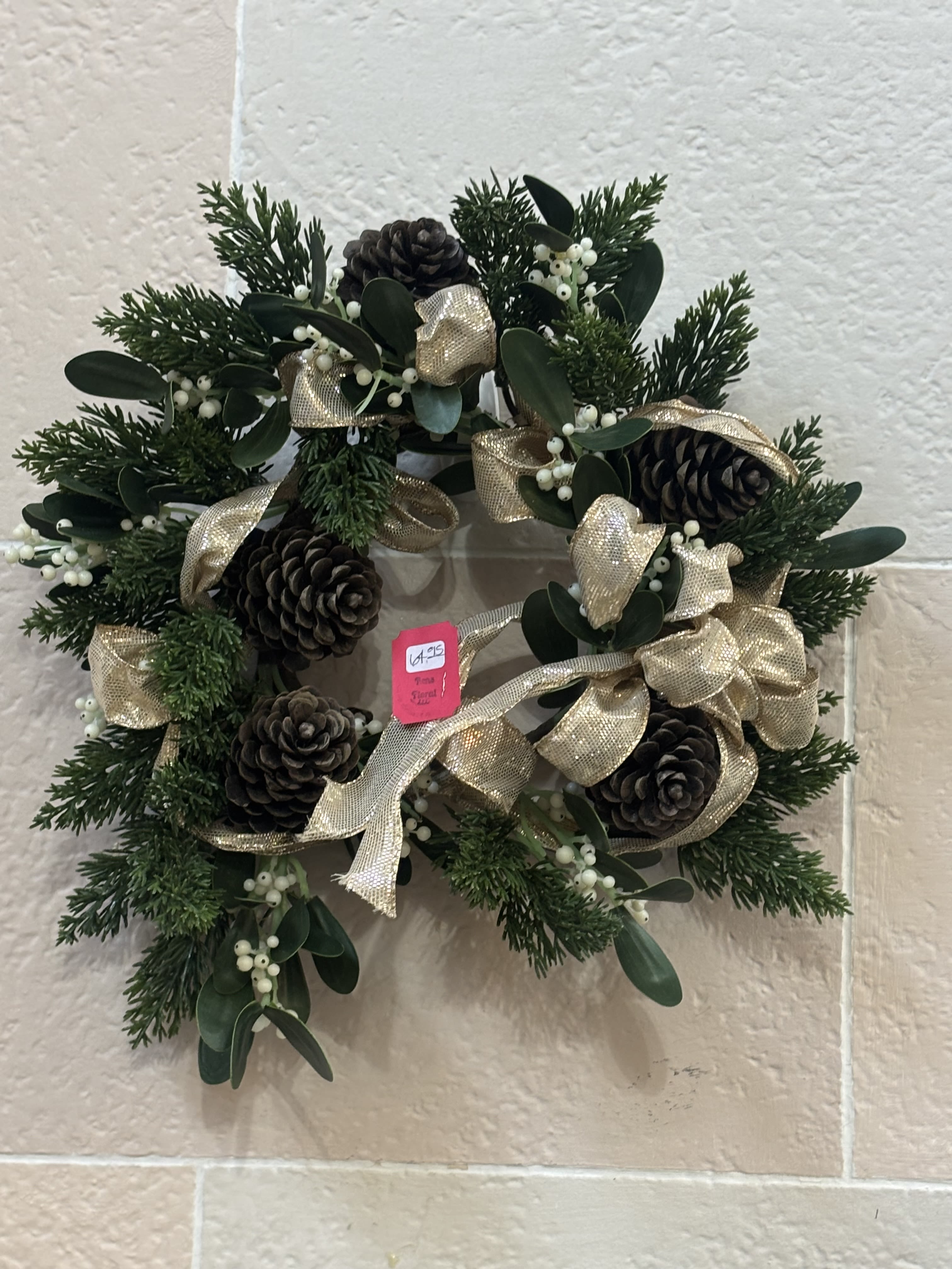 Gold Pinecone Wreath  - A pine wreath with pinecones and gold ribbon. 