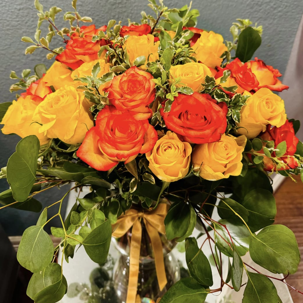 Golden Rosy - For sheer dazzle and excitement, nothing beats this magnificent bouquet. Mixed bouquet with greenery. Please Note:  We may sometimes need to use a different vase. If you prefere your roses without vase leave a note in your order