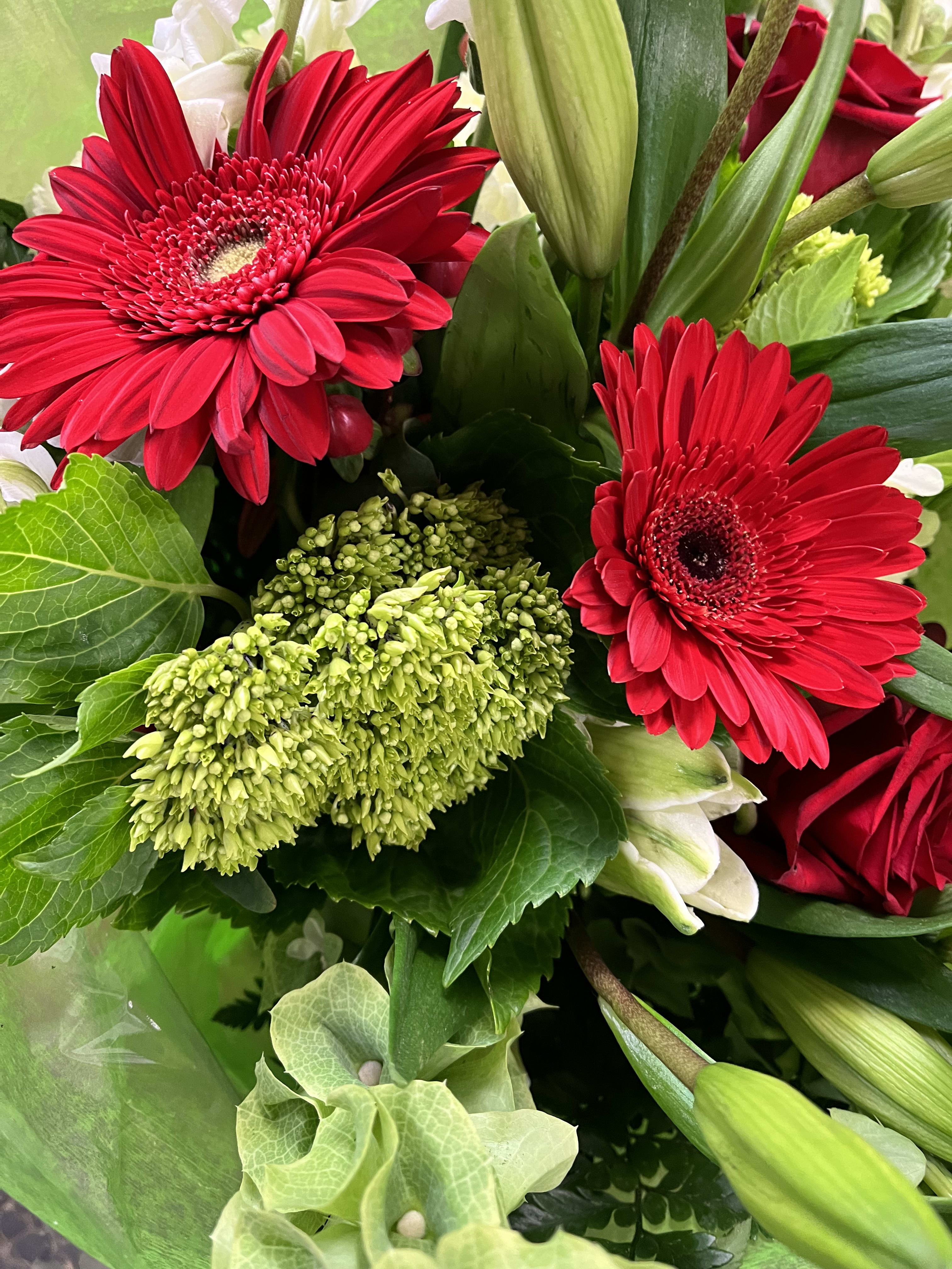 Seasonal loose bouquet  - Designers choice of seasonal red white and green flowers in a wrapped bouquet