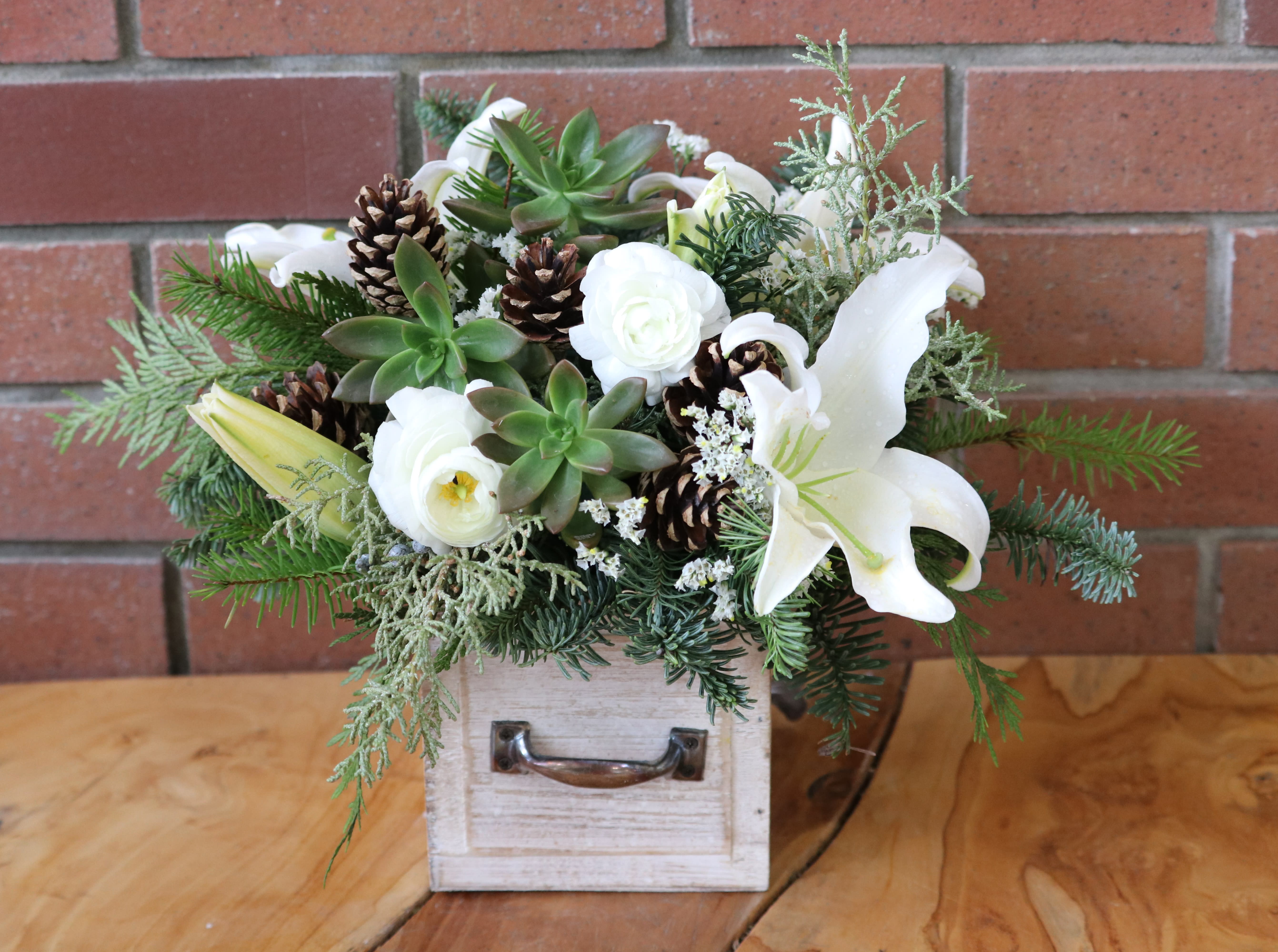 Woodland Bouquet  - Beautiful seasonal arrangement with fresh evergreens, white lilies, white ranunculus, pine cones and succulents in a white wash wooden drawer