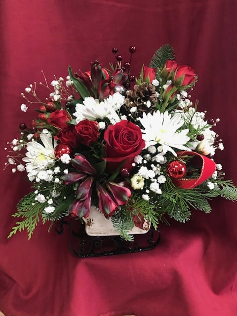 Our Vintage Porcelain Sleigh - Our collectable sleigh, filled with evergreens and flowers for the season.