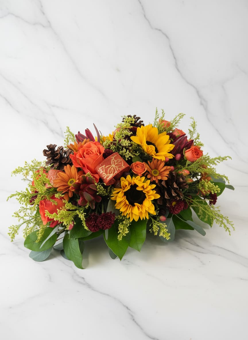Harvest cornucopia - Our harvest cornucopia will bring warmth and beauty to holiday table or Thanksgiving celebration. This fresh centerpiece, features bright flowers, button sprays, orange roses, hyper gum, barrier pinecones, Solidago and other premium foliage all gathered around a modern style cornucopia . 12’’L X 6’’H