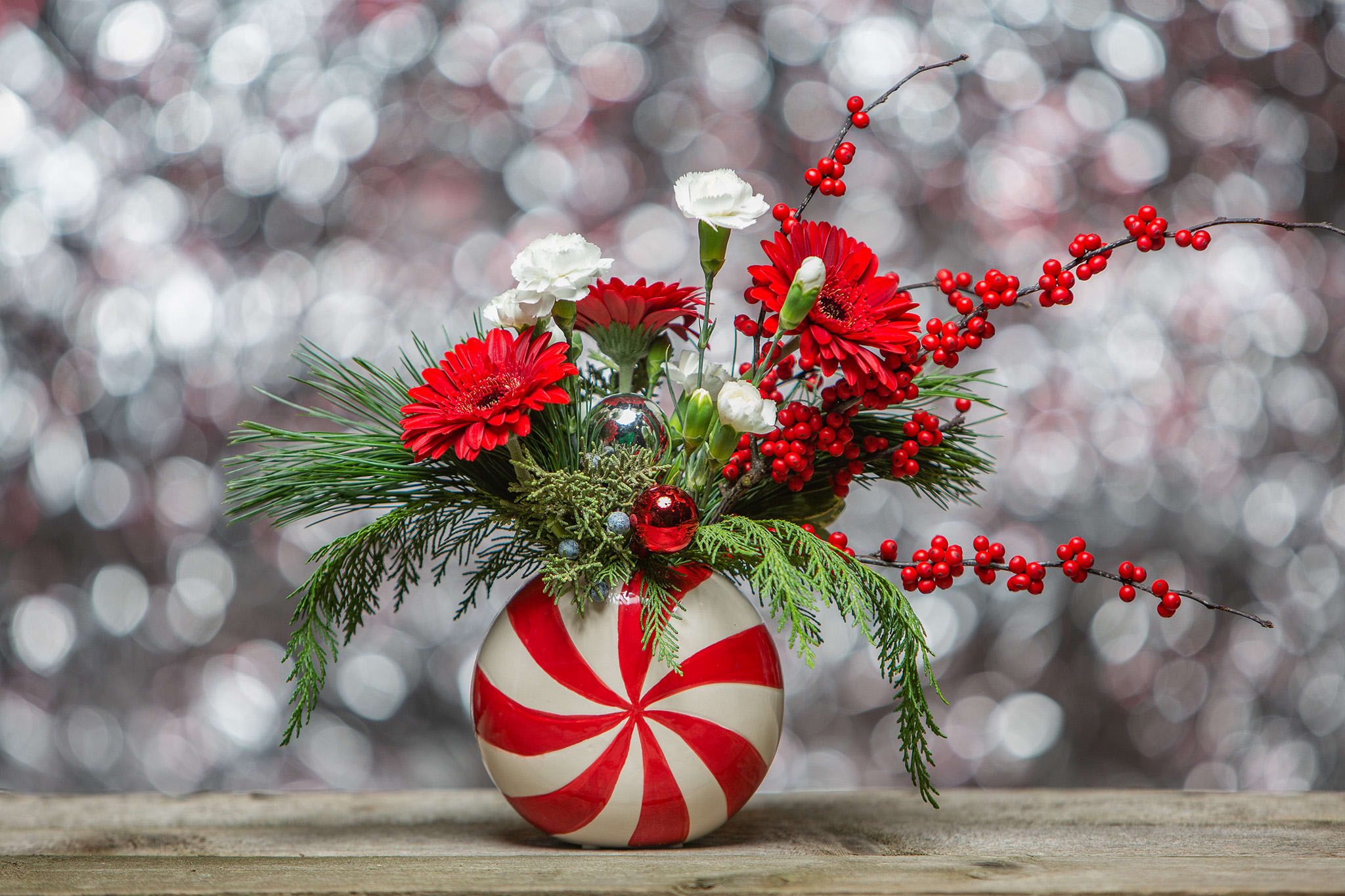 Peppermint Swirl - A darling 5x5 ceramic vase holding Christmas blossoms, berries and holiday foliage. Designed and delivered by us, a real Portland florist to anywhere in the greater Portland Oregon area. Place your order online, or call us directly 503 223 1646