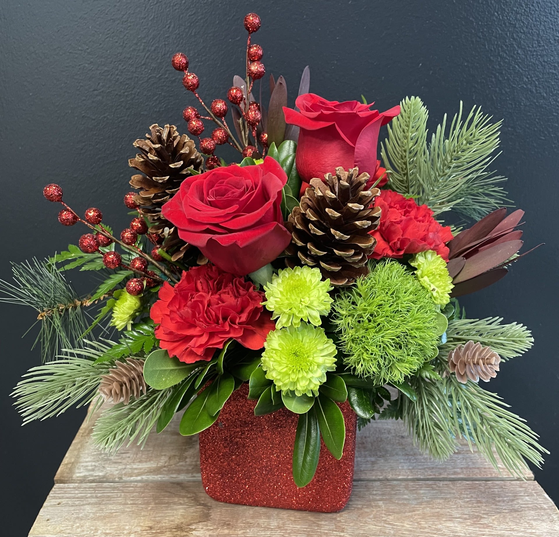 Holly Jolly  - The &quot;Holly Jolly&quot; arrangement is a vibrant and cheerful blend of red and green in a festive red dazzling container. 