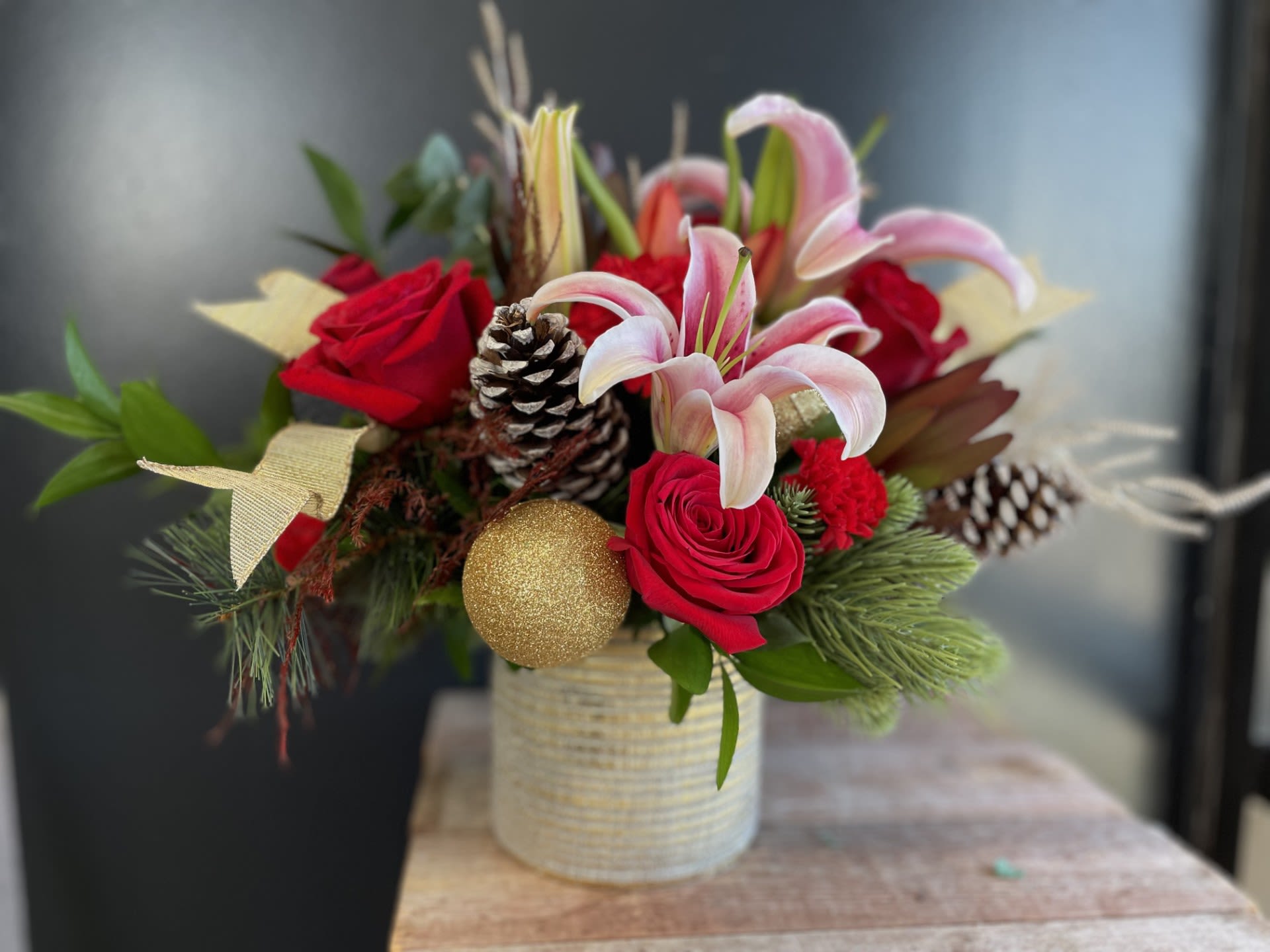 Yuletide Elegance - This &quot;Yuletide Elegance&quot; arrangement is a harmonious blend of rich reds and sparkling golds, embodying the festive spirits. 