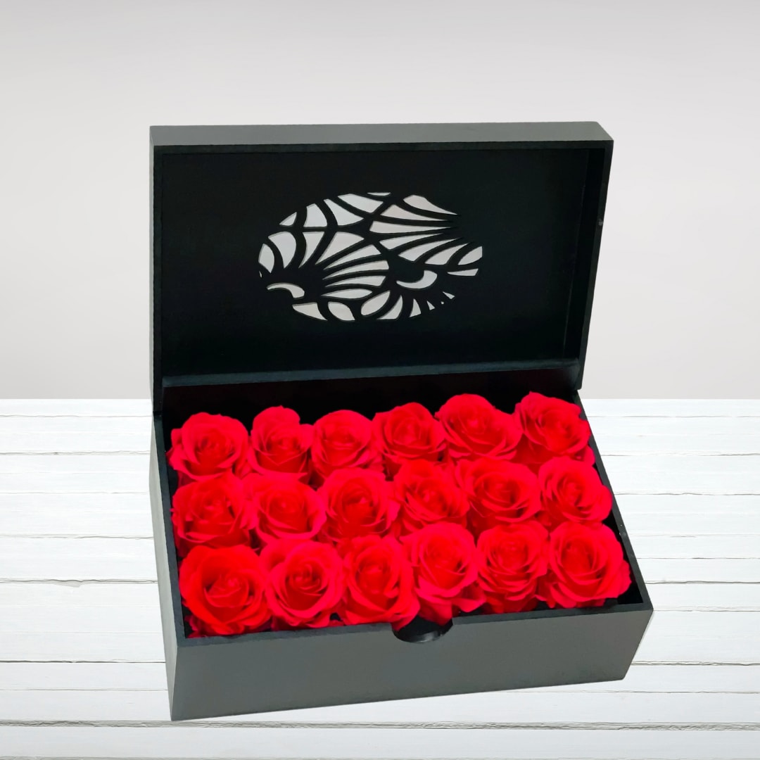 Real Preserved Red Roses Etui Box (18 Roses) - Enjoy our incredible new Preserved Roses! We have partnered with a company utilizing patented technology that allows you to enjoy this product for up to a year. This arrangement features 18 stunning red roses, preserved to maintain their natural beauty and freshness without the need for watering or maintenance.    Key Features:    Preserved Red Roses: Includes 18 preserved red roses, maintaining their vibrant color and soft texture for up to a year.    Patented Technology: Utilizes patented preservation technology, ensuring long-lasting beauty without maintenance.    Elegant and Timeless: Perfect for adding elegance and charm to any space, offering a lasting reminder of your affection.    No Maintenance Required: Requires no watering or special care, making it an ideal choice for busy lifestyles.    Ideal Gift: A thoughtful gift for anniversaries, birthdays, or any special occasion, symbolizing enduring love and appreciation.    Experience the beauty of our Preserved Red Roses, a perfect blend of innovation and natural elegance, designed to delight and inspire for months to come.
