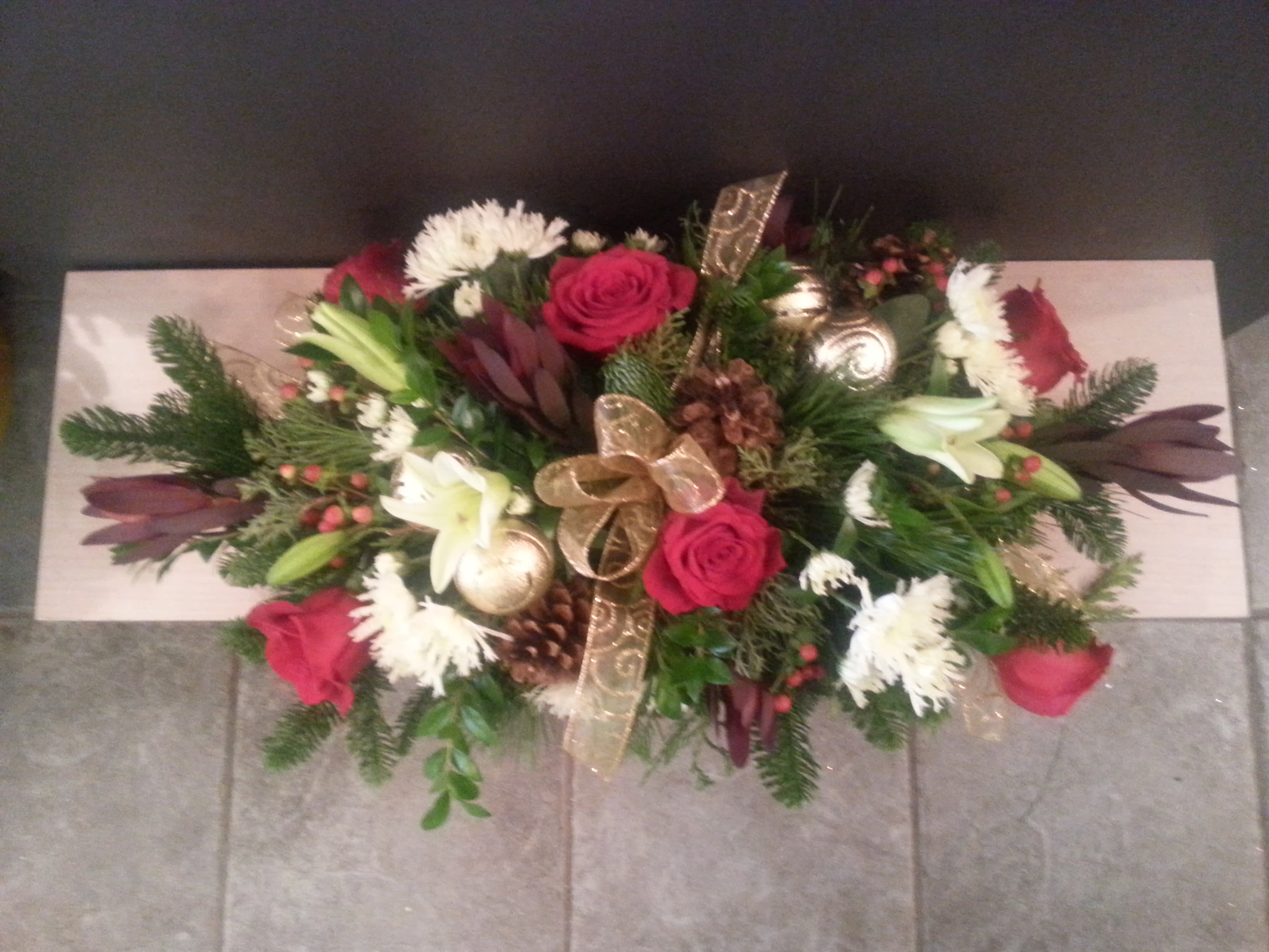Long and elegant holiday Centerpiece   - Elegant mix of holiday flowers and greens. 