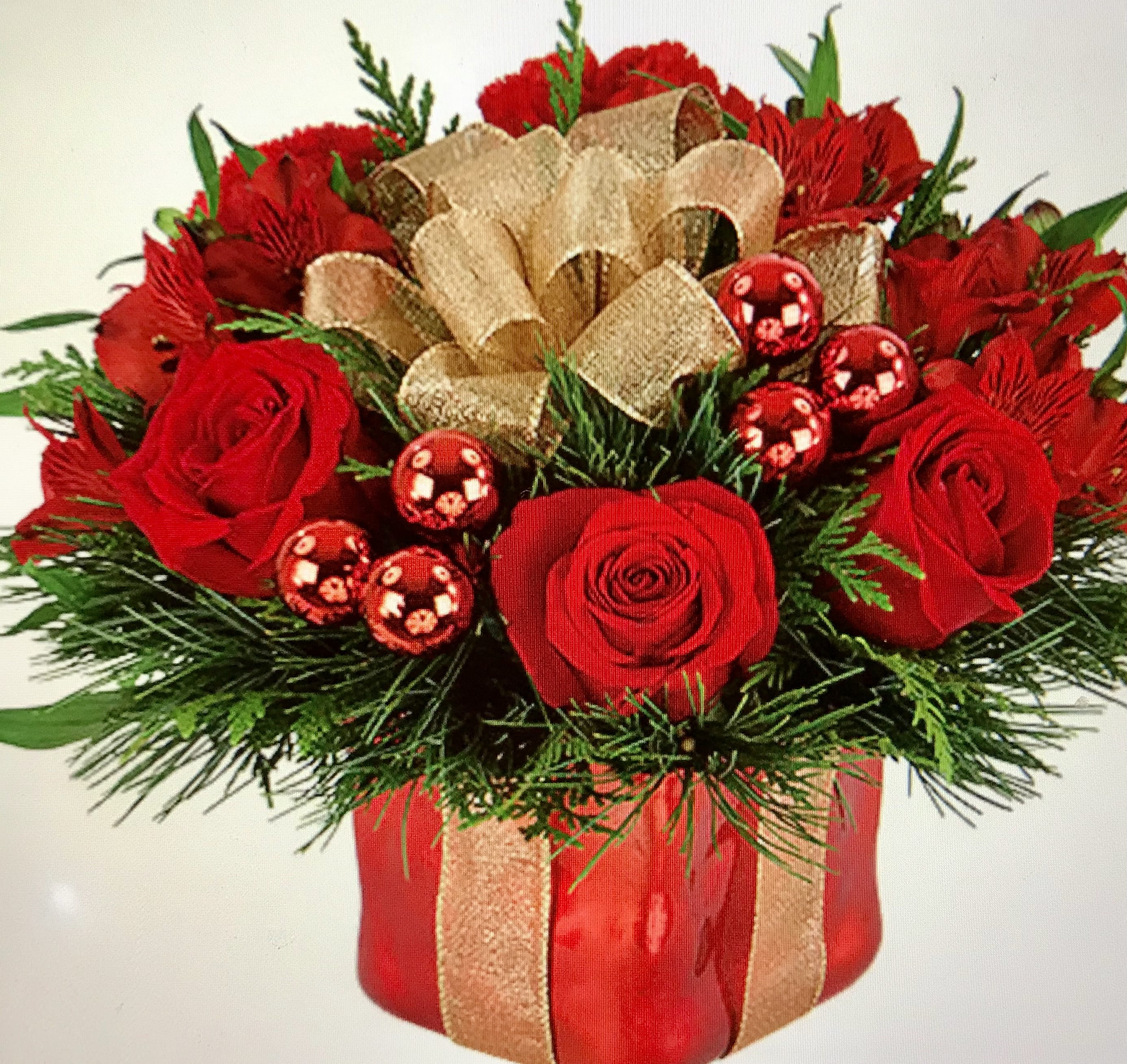  The Christmas Candle   - In a red vase combination of red roses, Xmas greenery, red balls and gold bow