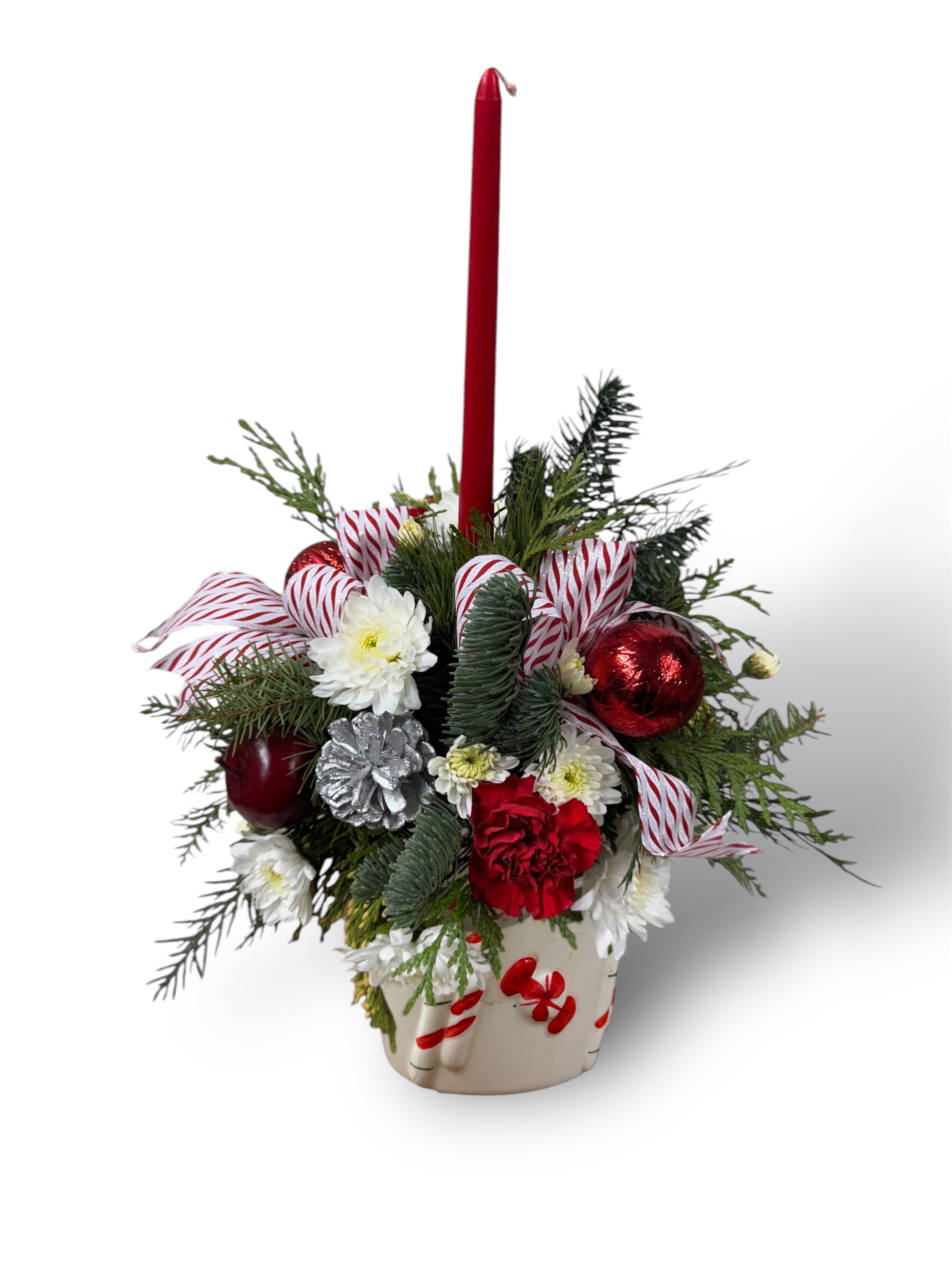 SANTA'S CENTERPIECE  - Santa Centerpiece: A Lush Display of Mixed Evergreens, Red and White Blooms, Festive Ribbon Tufts, Sparkling Silver Pine Cones, Shimmering Ornaments, and Elegant Candle Accents”