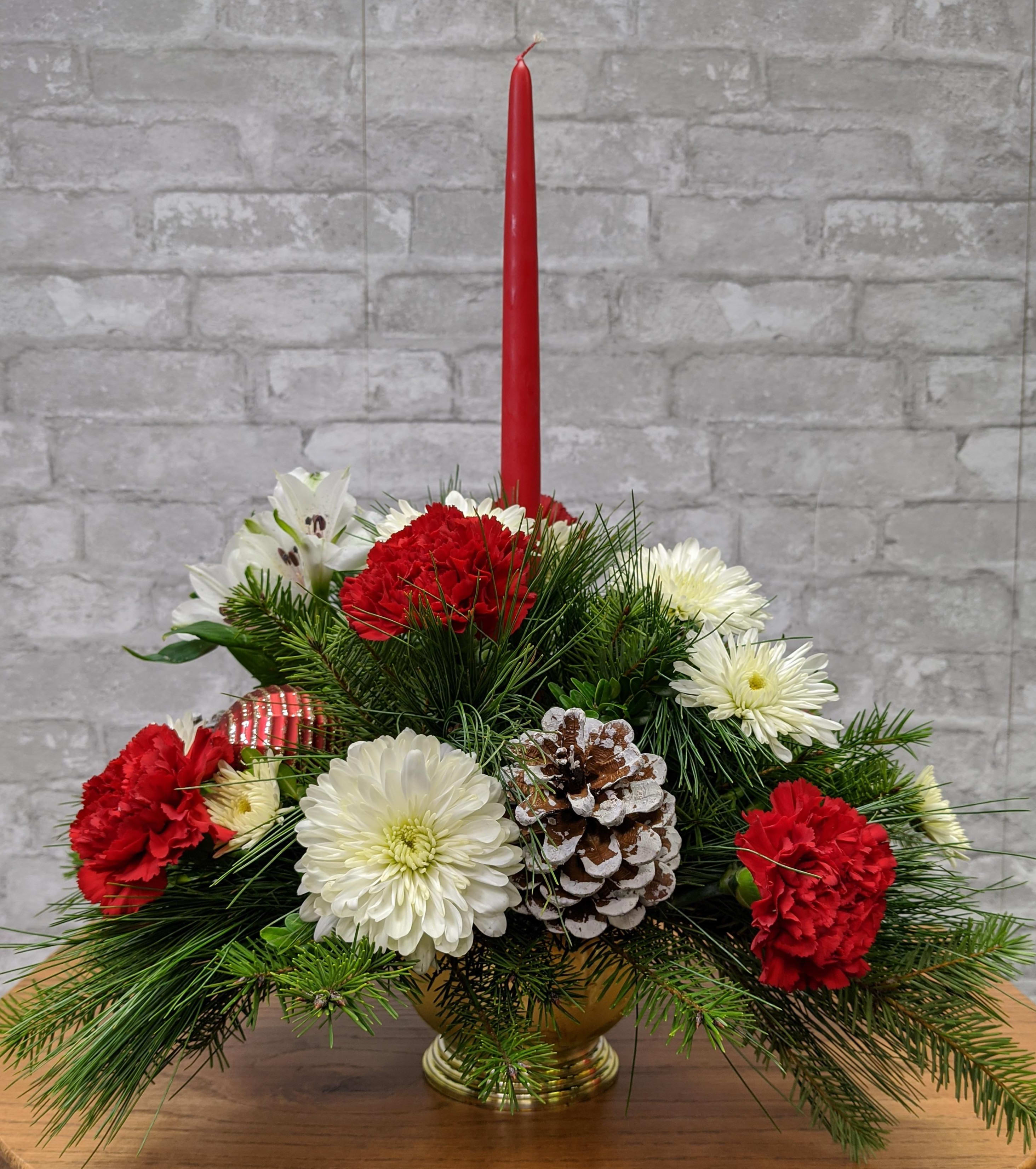 Christmas Traditions FG - Charming centerpiece with red taper candle, red carnations and white mums, winter greens, pine cones.  